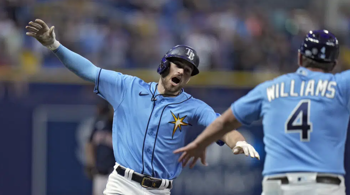 Tampa Bay Rays' Brandon Lowe celebrates with third base coach Brady Williams (4) after his solo home run off Boston Red Sox relief pitcher Chris Martin during the eighth inning of a baseball game Monday, April 10, 2023, in St. Petersburg, Fla.