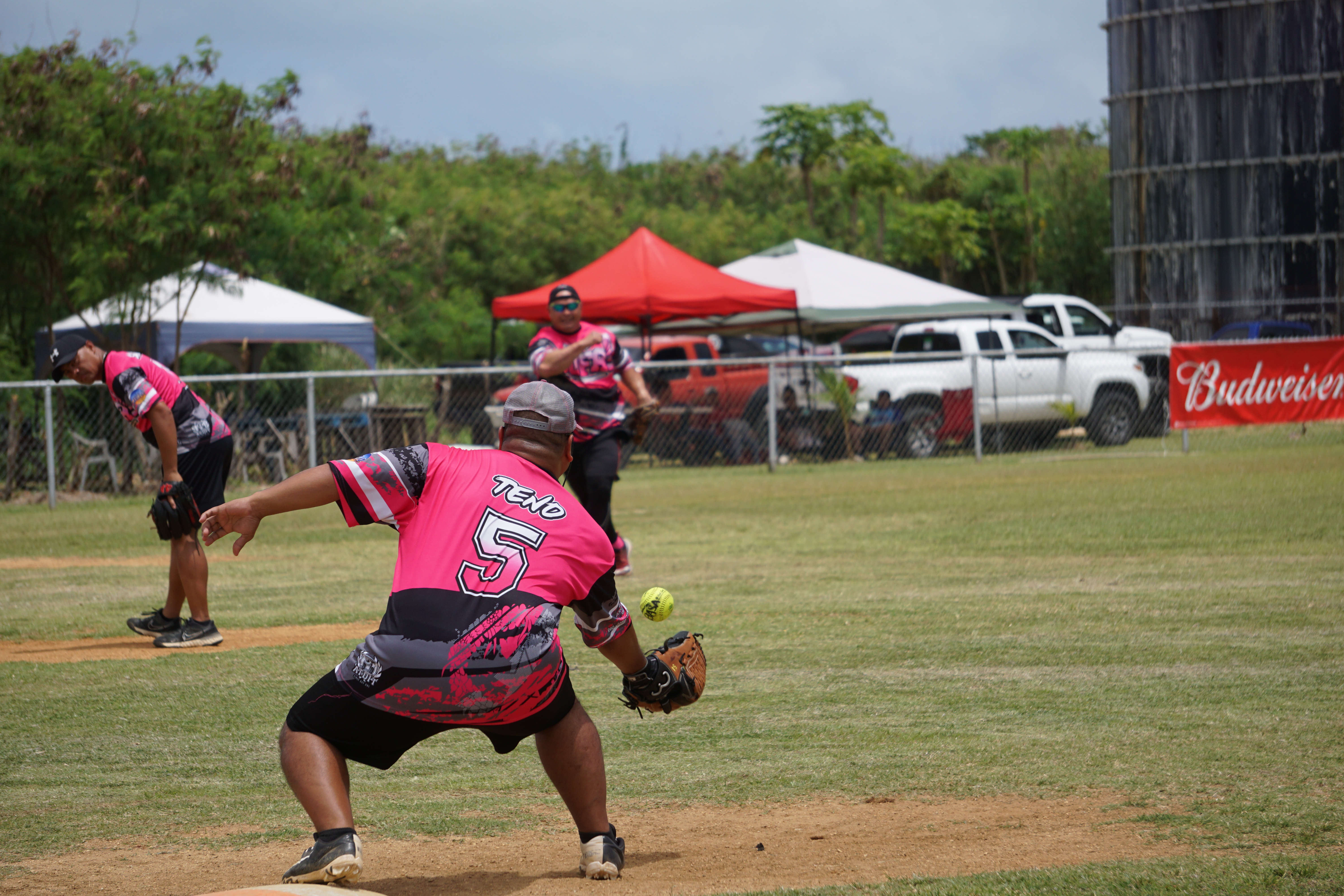 SUFA shortstop Mario Aguon throws to first baseman Mel Tenorio for the out during a 2023 Budweiser Belau Amateur Softball League game at the Dandan baseball field.