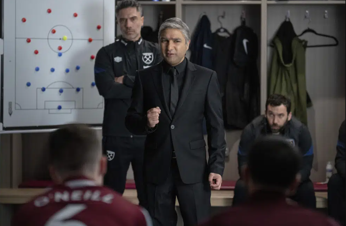 This image released by Apple TV+ shows Nick Mohammed, center, in a scene from "Ted Lasso."