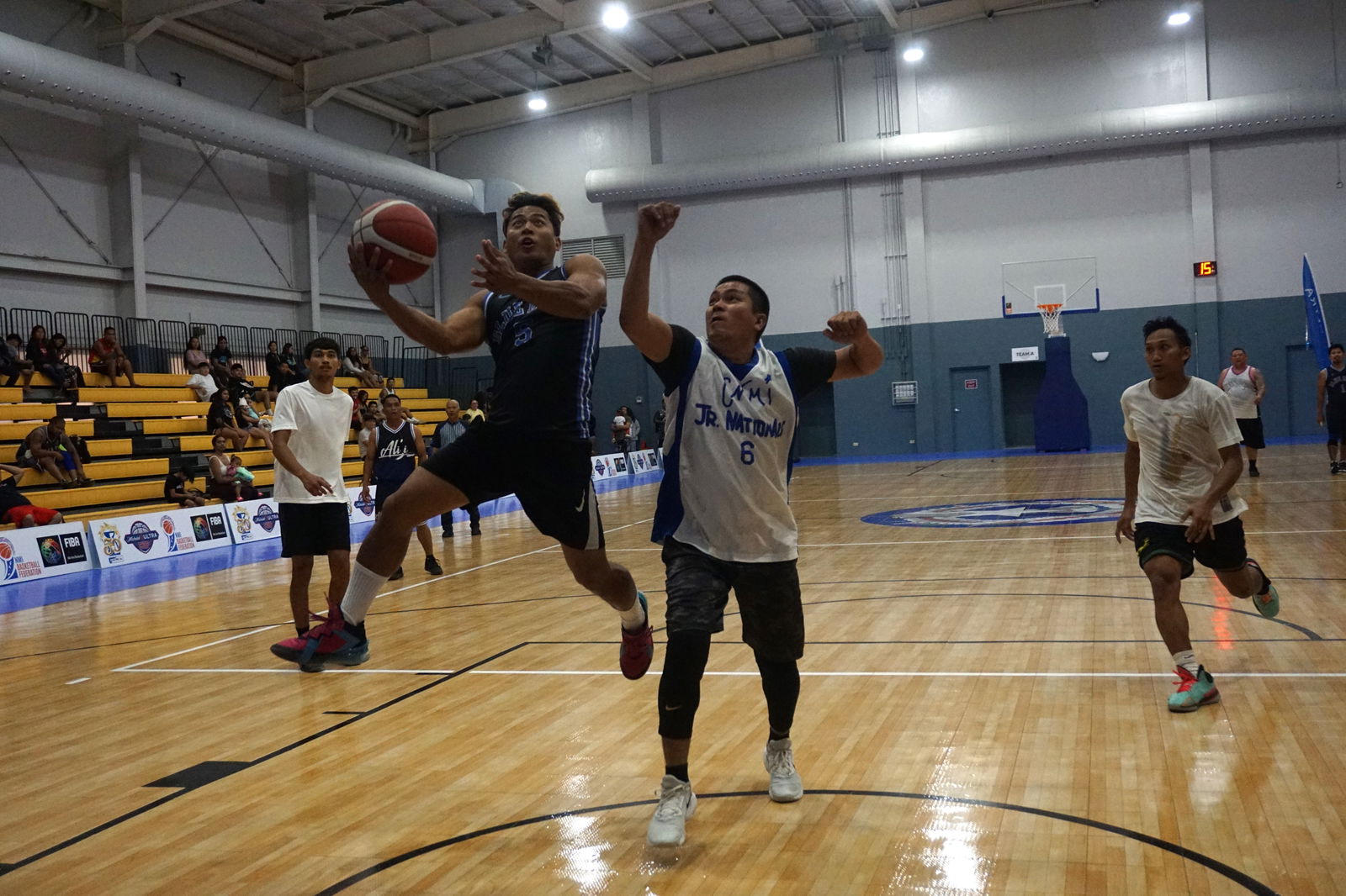 Ali'i Blue Haus' Reymark Castro extends for the finish during a  Michelob Ultra Cup 2023 game Saturday at the  Ada gym.