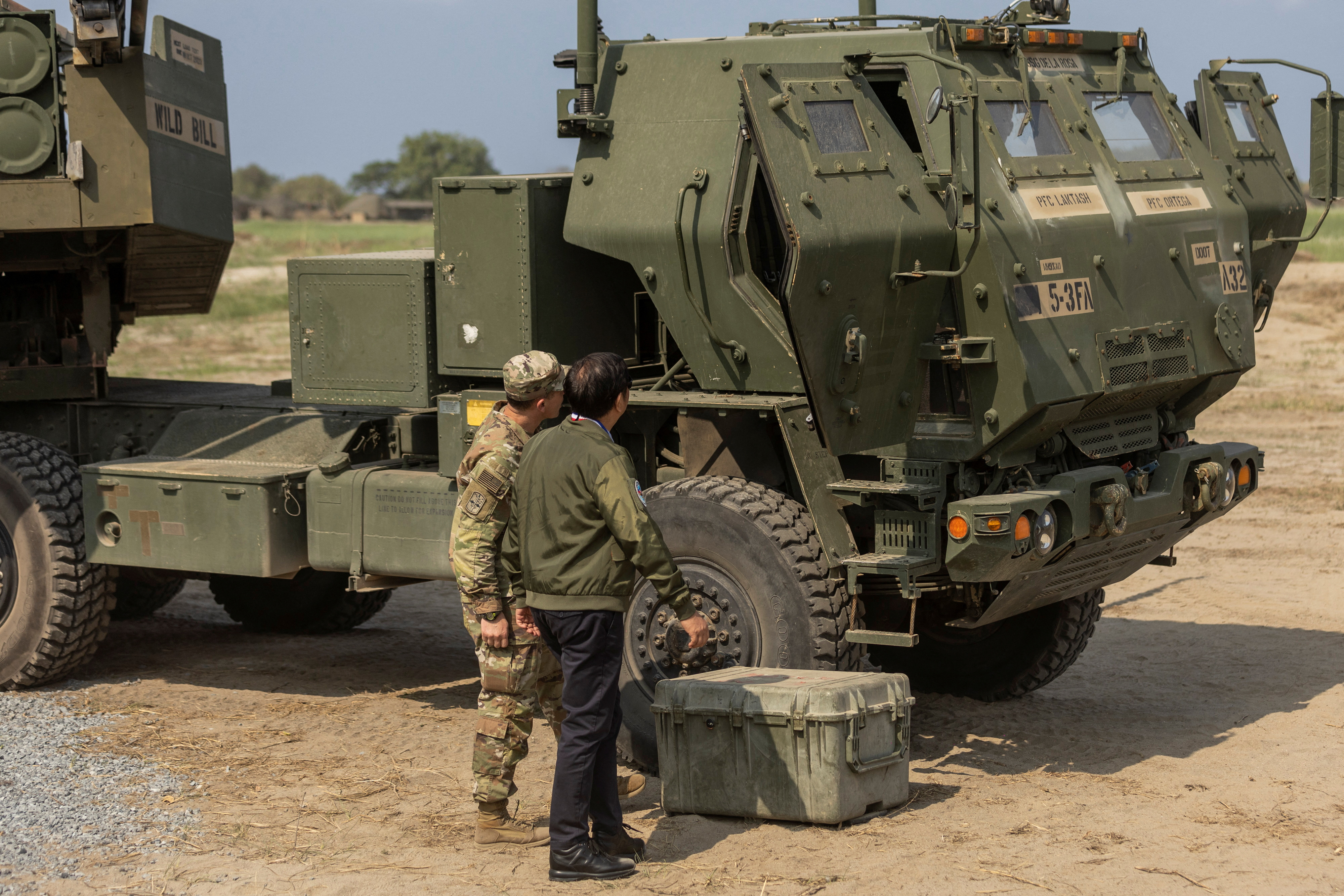 Philippine President Ferdinand "Bongbong" Marcos Jr. inspects a high mobility artillery rocket system (HIMARS) beside a U.S. soldier before a live fire exercise in the annual joint military exercises between U.S. and Philippine troops called "Balikatan" or shoulder-to-shoulder, held in San Antonio, Zambales province, Philippines, April 26, 2023. REUTERS/Eloisa Lopez