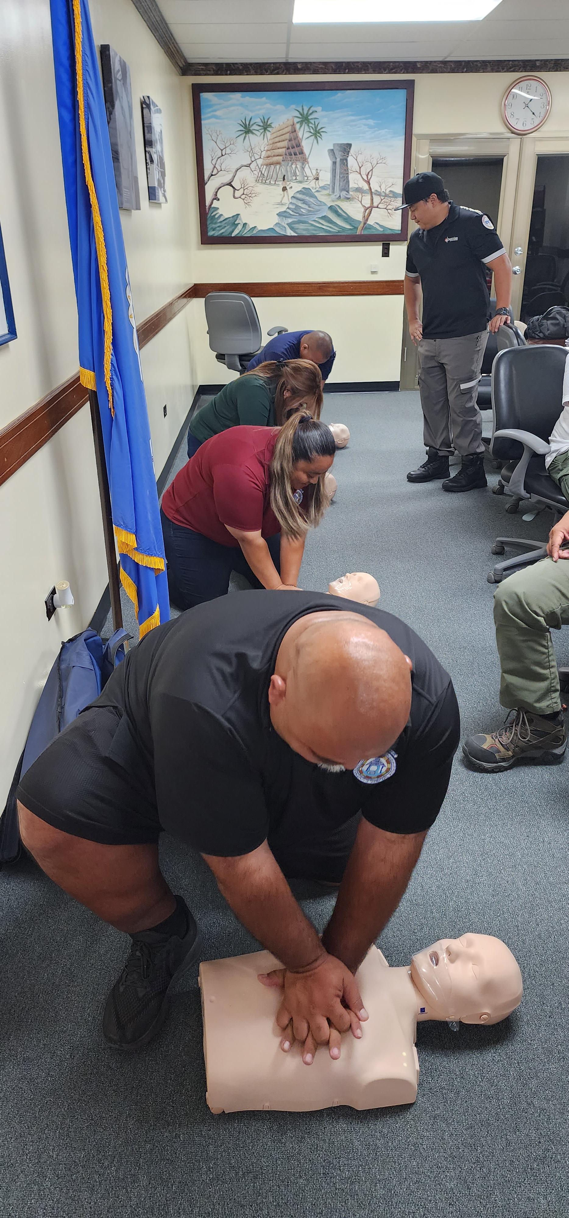 The staff of the Saipan Mayor's Office practice giving CPR to CPR dolls. In photo are Operations Director Joseph Attao, HR Specialists Elaine Limes, Home Number Division Supervisor Janice Celis and Saipan Dog Control Program Field Supervisor Leemark Deleon Guerrero.