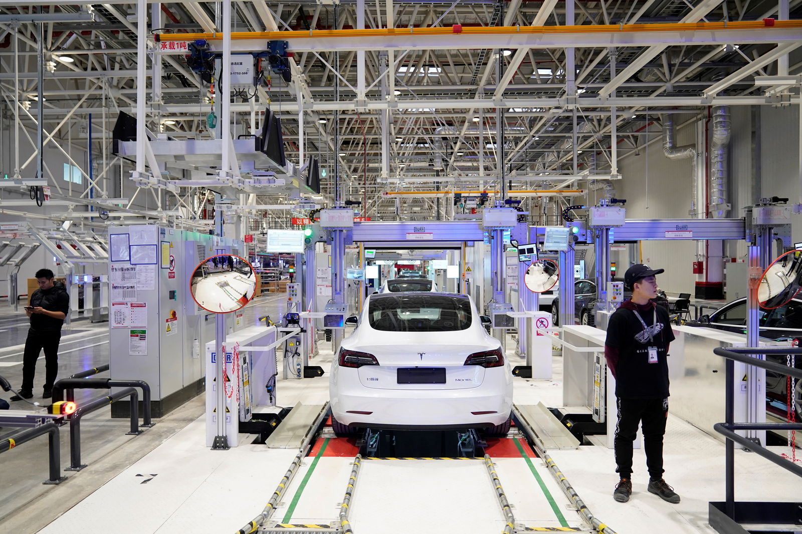 FILE PHOTO: Tesla China-made Model 3 vehicles are seen during a delivery event at its factory in Shanghai, China January 7, 2020. REUTERS/Aly Song