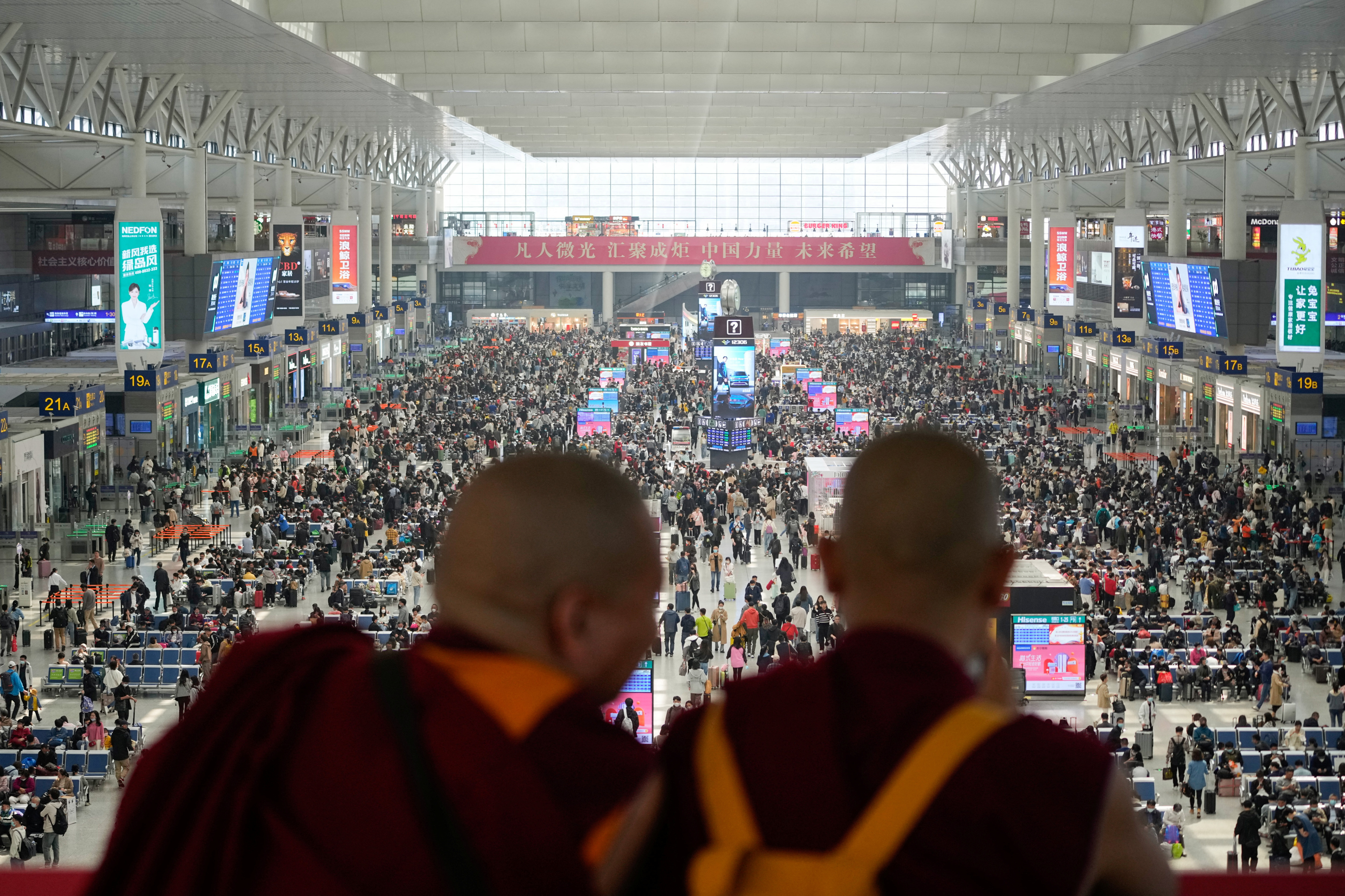 Monks take pictures with phone at Shanghai Hongqiao railway station ahead of the five-day Labor Day holiday, in Shanghai, China, April 28, 2023. REUTERS/Aly Song