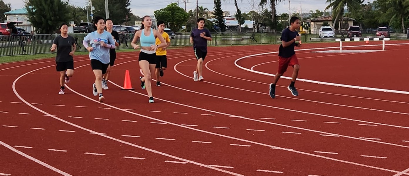 Runners battle for the lead in the 1500M race of the middle/high school division of the PSS-NMA All School Athletics qualifying meet on Saturday at the Oleai Sports Complex.