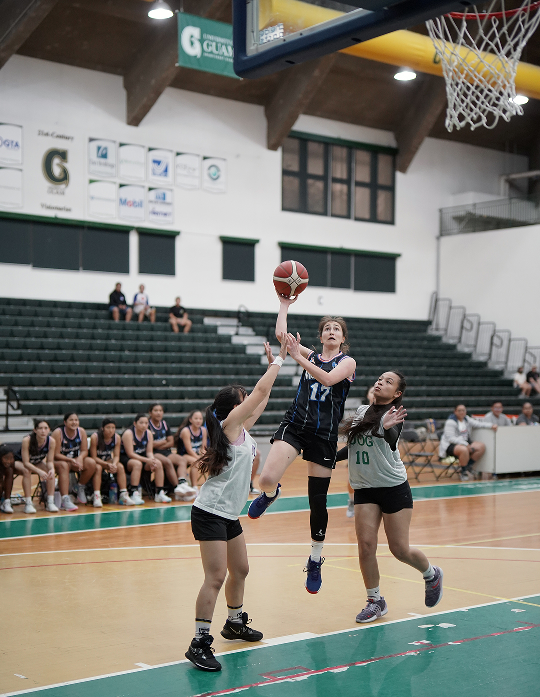 Team Marianas' Gabrielle Race takes the contested shot in a game against the UOG Tridents during the 2nd Annual UOG Friendship Games at the UOG Calvo Field House.