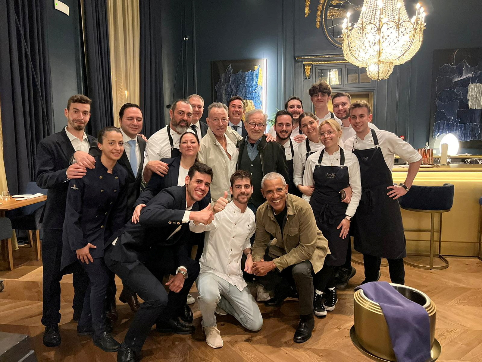 Former U.S. President Barack Obama, film director Steven Spielberg and singer Bruce Springsteen pose for a picture with Amar restaurant staff in Barcelona, Spain April 27, 2023, in this picture obtained from social media. Pol Perello Franch/via REUTERS
