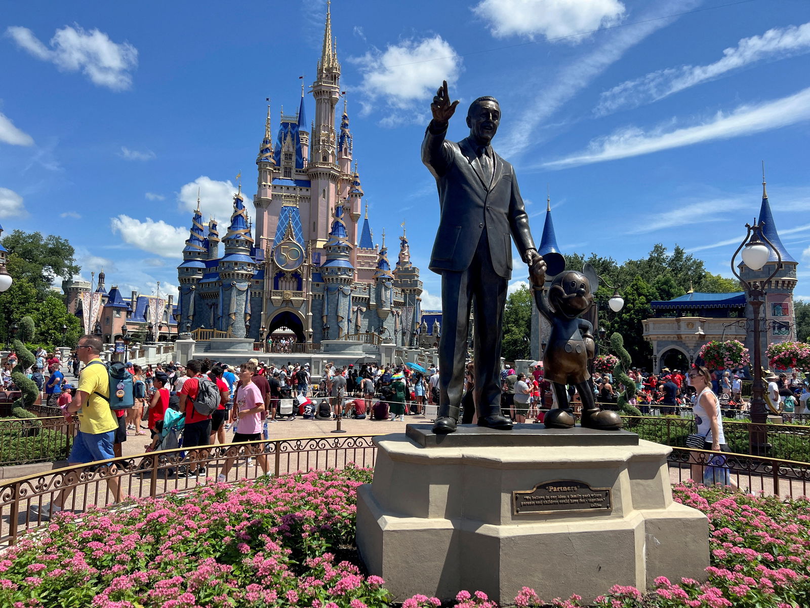 People gather at the Magic Kingdom theme park before the "Festival of Fantasy" parade at Walt Disney World in Orlando, Florida, July 30, 2022.
