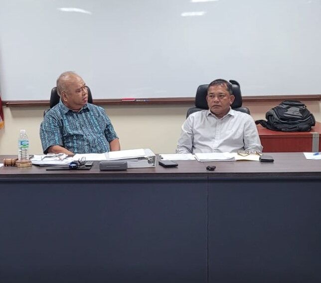 Commonwealth Casino Commission Chairman Edward C. Deleon Guerrero, left, talks with Vice Chairman Ralph Demapan during a meeting on Thursday at the CCC office at Springs Plaza in Gualo Rai.