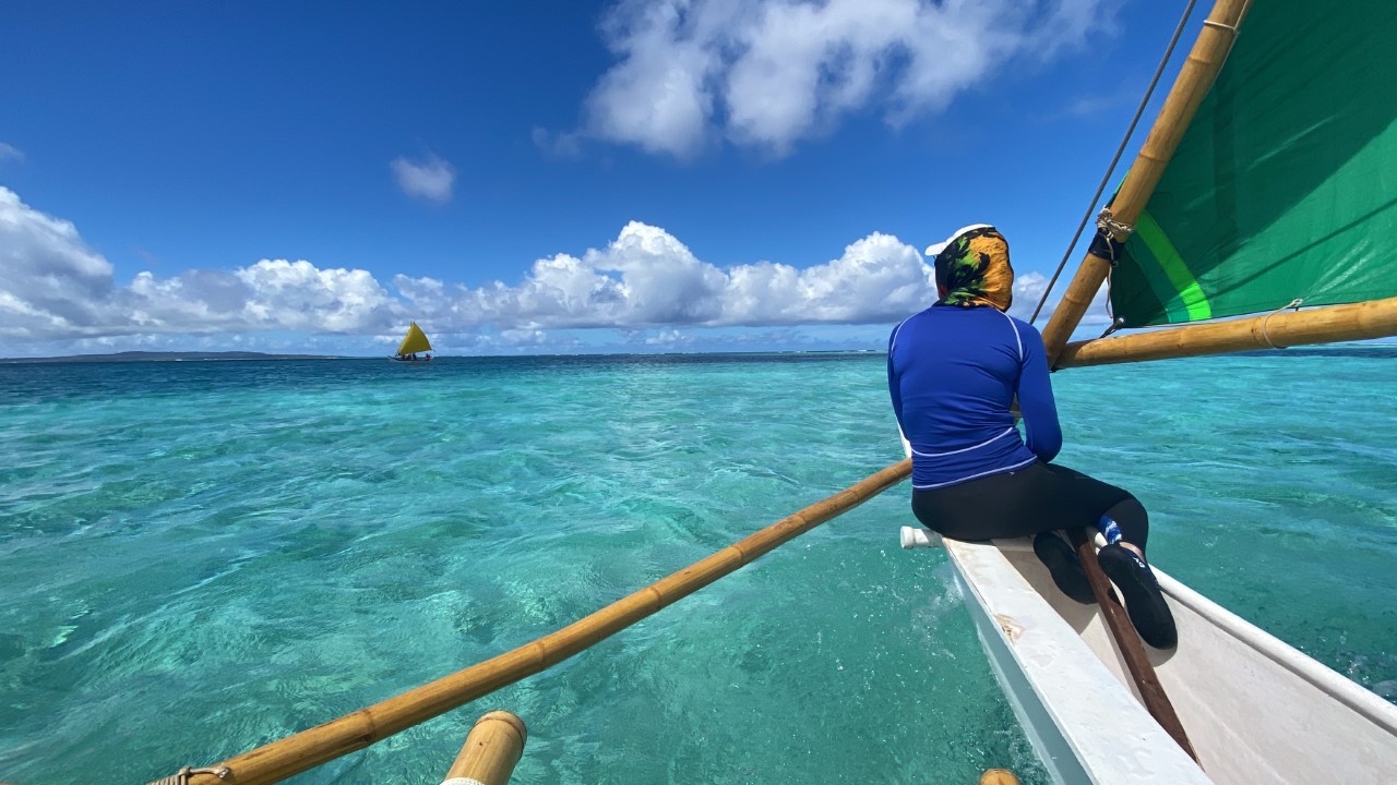 This photo was taken in the Saipan lagoon near  Saipan World Resort. Here two 500 Sails canoes are pictured: Neni, green sail; and Aunty Oba, yellow sail