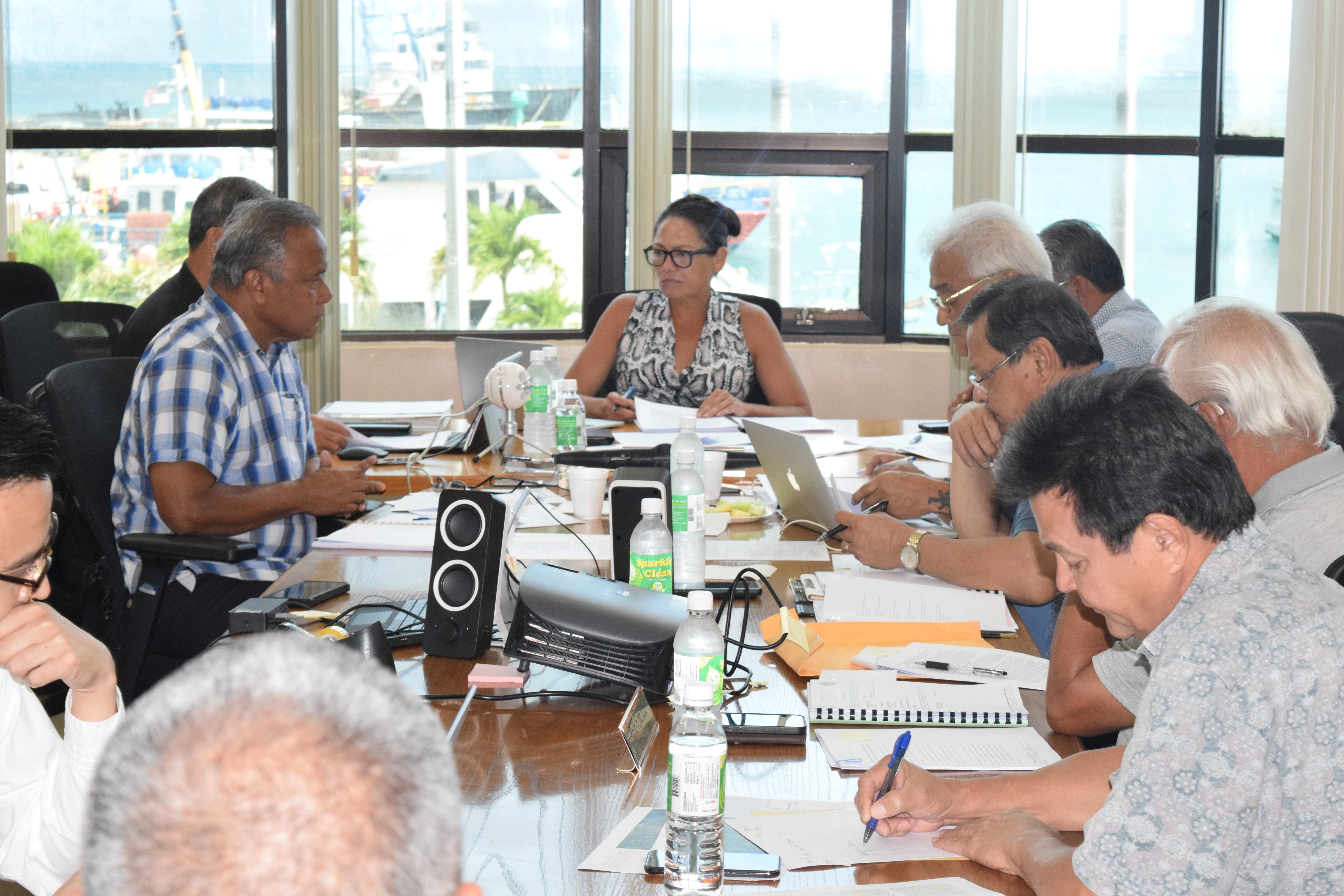 Commonwealth Ports Authority Board Chair Kimberlyn King-Hinds, center, listens to board member Ramon A. Tebuteb, left, as other board members read documents during a meeting in the Port of Saipan conference room on Tuesday.