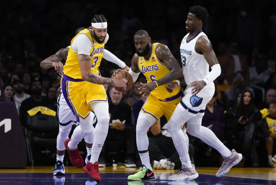 Los Angeles Lakers' LeBron James (6) dribbles under pressure from Memphis Grizzlies' Jaren Jackson Jr., right, as Lakers' Anthony Davis (3) makes his way downcourt during the first half in Game 4 of a first-round NBA basketball playoff series Monday, April 24, 2023, in Los Angeles.
