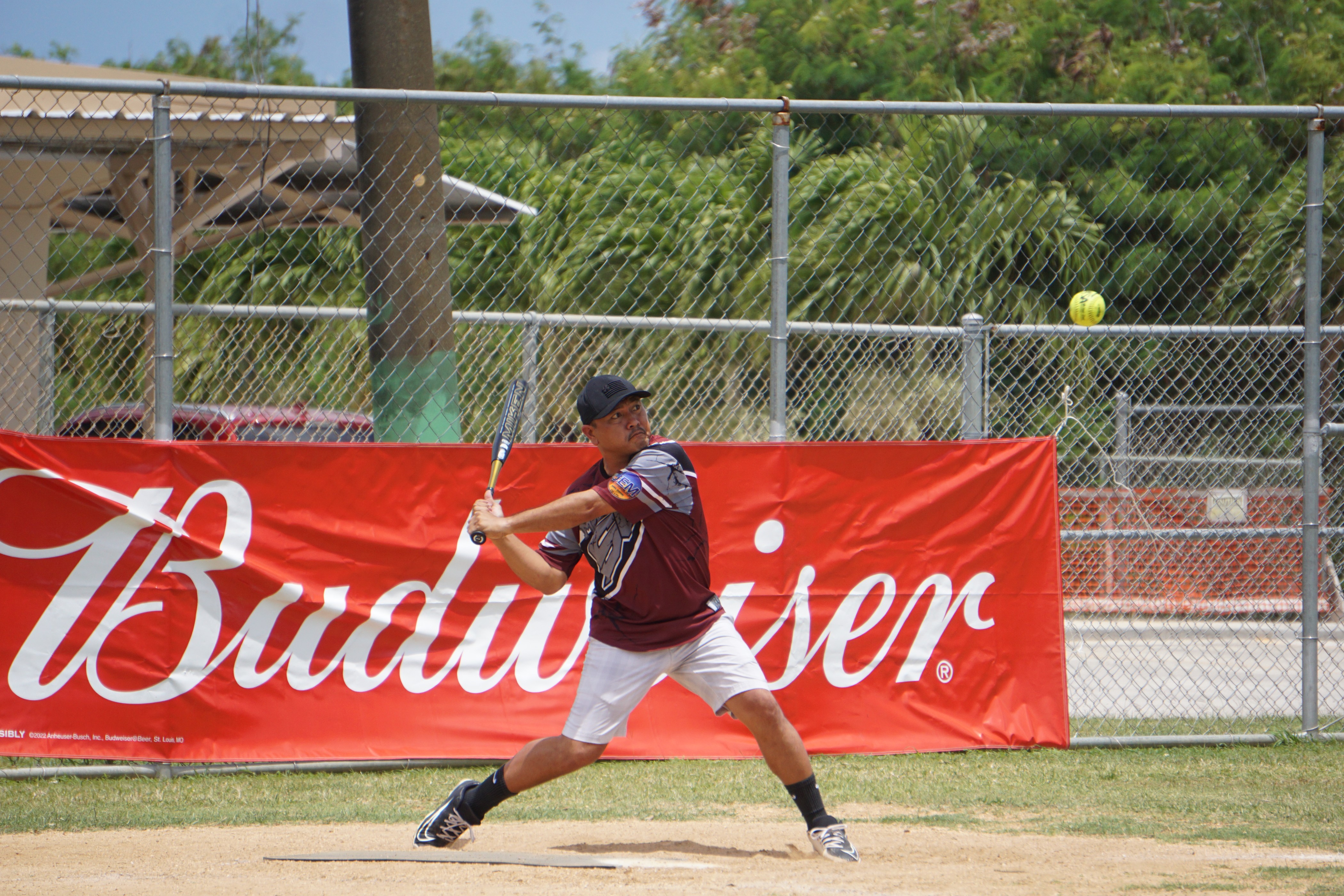 SUFA's Deleon Guerrero winds up for the hit during a game against TuTuRamz in the 2023 Budweiser Belau Amateur Softball League Sunday at the Dandan baseball field.