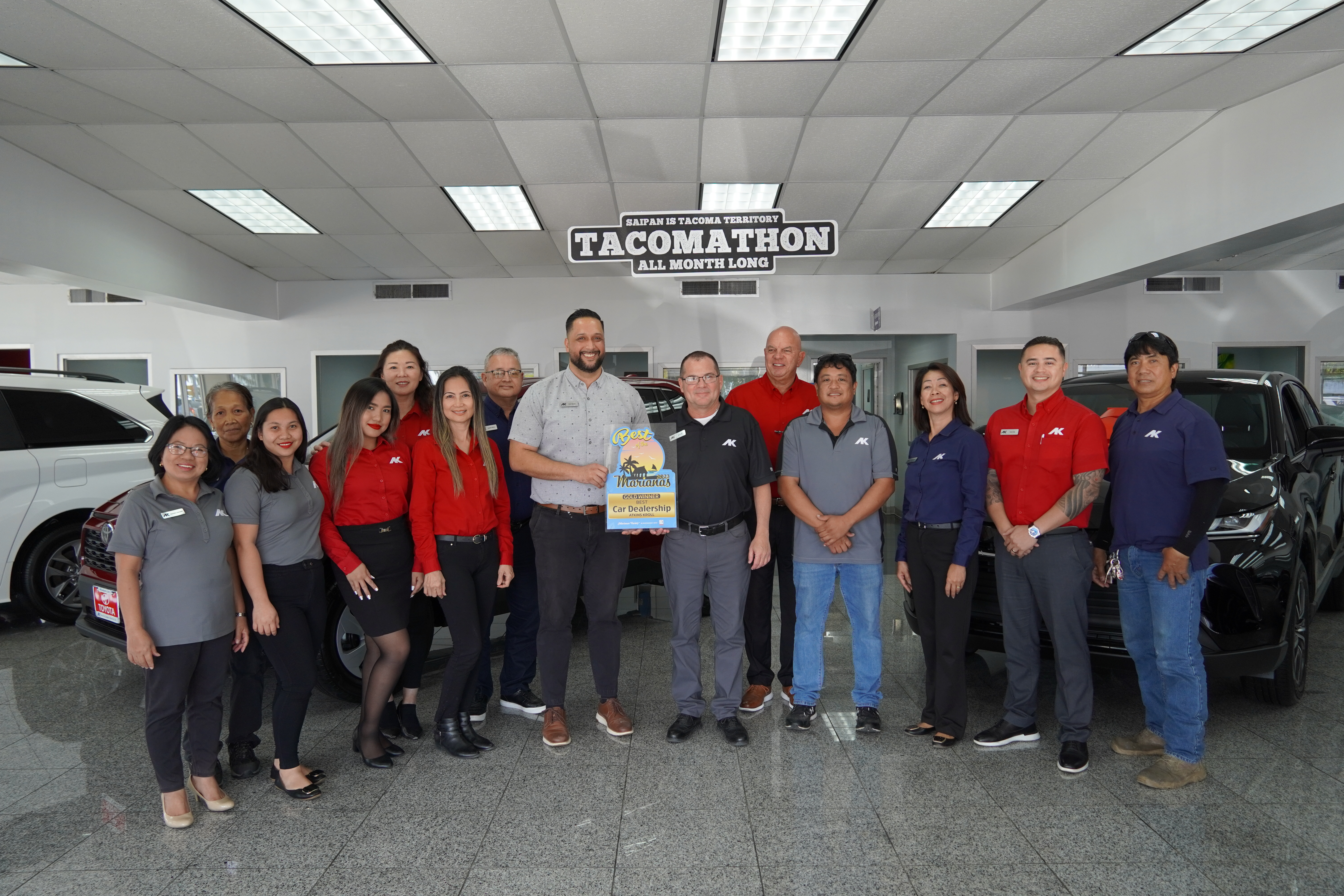 Joel Lesh, center, Atkins Kroll Saipan general manager, and Kevin Barnes, sales manager, receive the Gold award for Best Car Dealership of the Marianas.