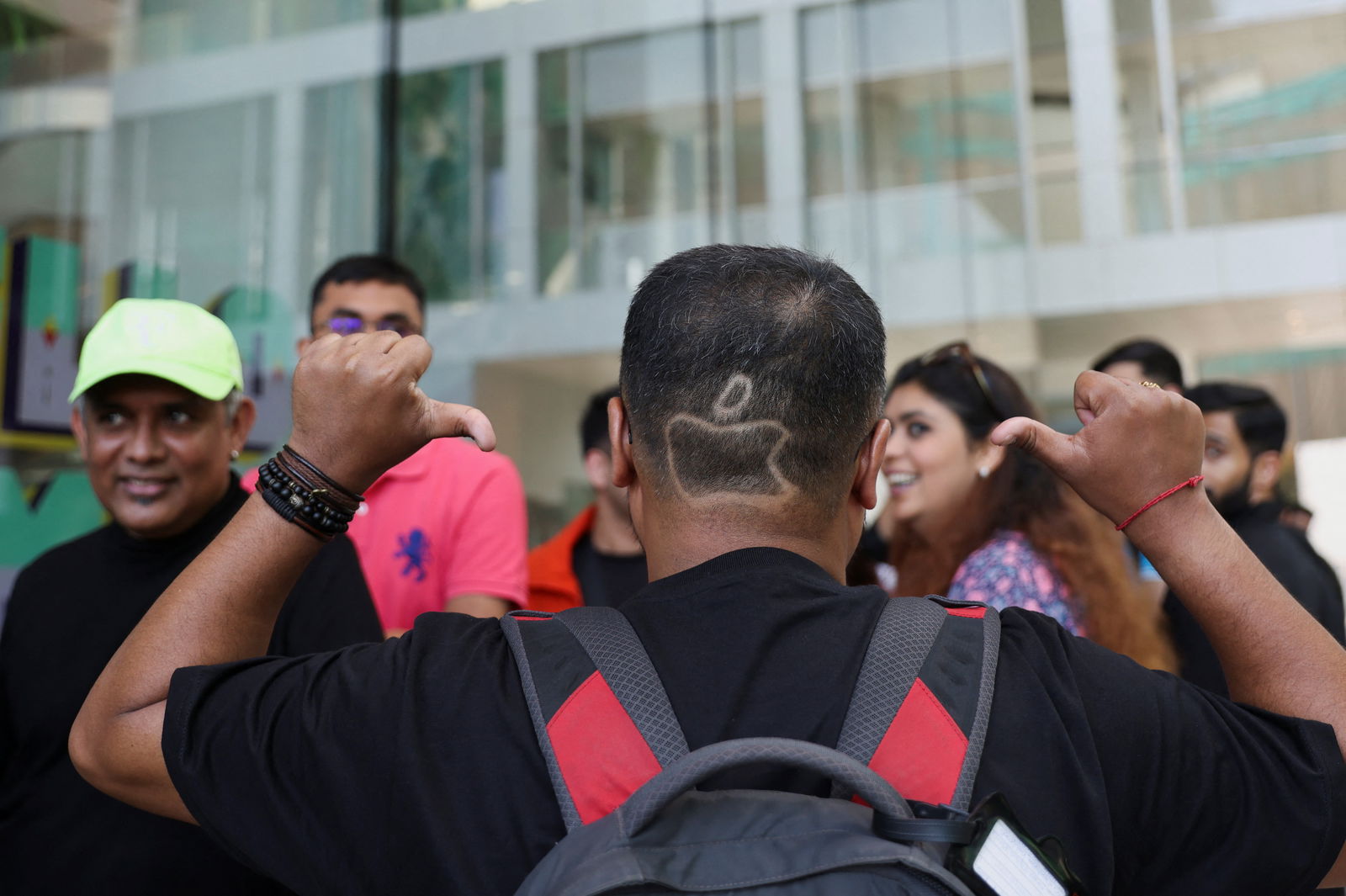 Apoorv Rao, an Apple fan from Bangalore, sports a haircut depicting the Apple logo as he waits in a queue outside India's first Apple retail store on the day of its opening in Mumbai, India, April 18, 2023. REUTERS/Francis Mascarenhas