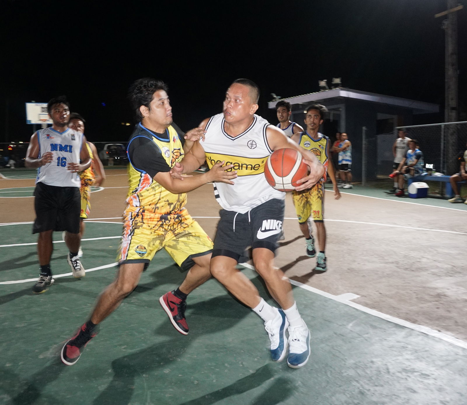 The Game's Arnold Arellano gets fouled as he goes in for the shot during an open division game of the Saipan Centennial Lions Club Invitational Basketball League at the Civic Center basketball court on Friday.