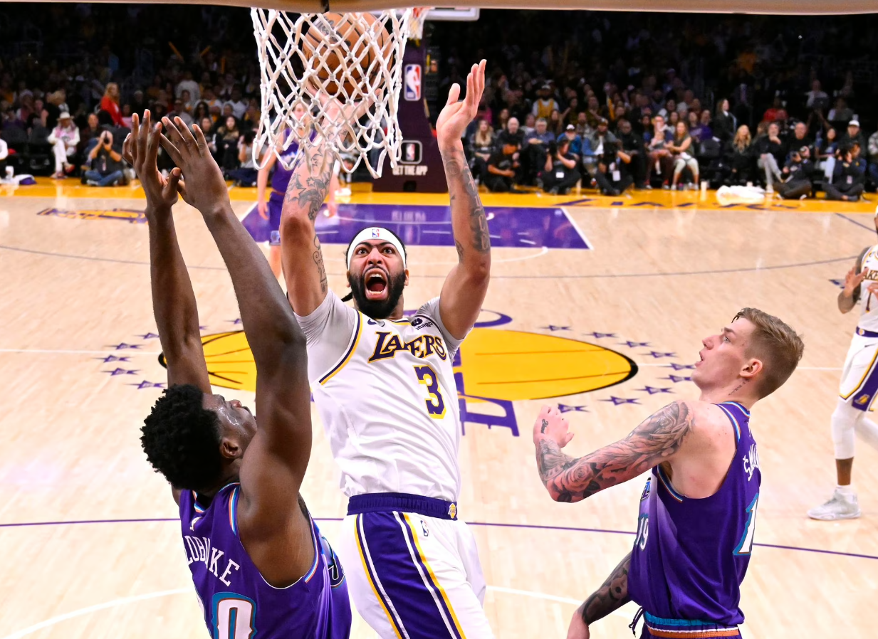 Los Angeles Lakers forward Anthony Davis (3)shoots over Utah Jazz center Udoka Azubuike (20) and forward Luka Samanic (19) for a basket in the second half at Crypto.com Arena in Los Angeles, California, April 9, 2023.