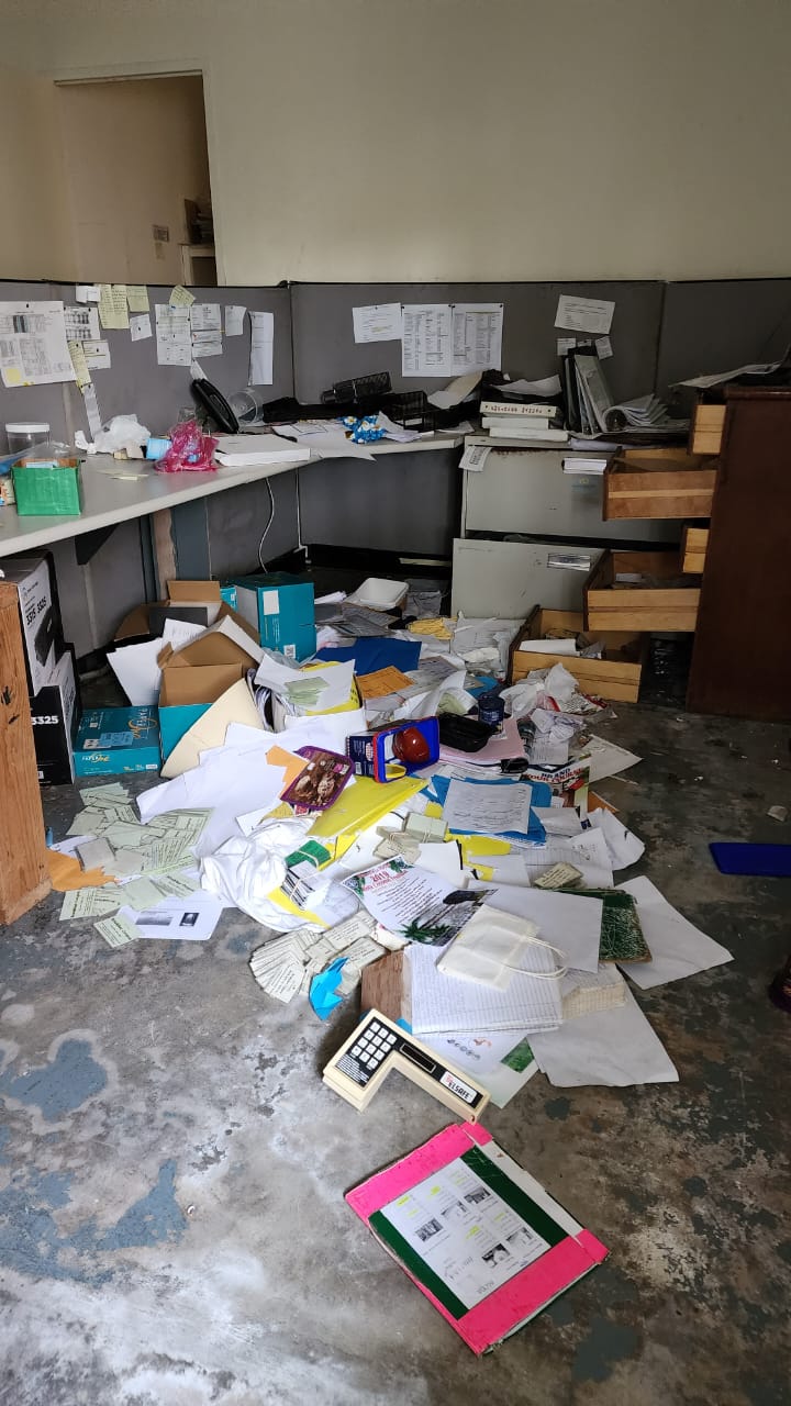 Paper and office items are scattered on the floor of the Rota Resort office.