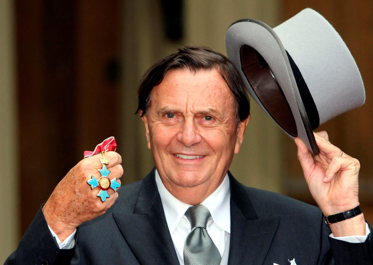 Australia's Barry Humphries poses after receiving his Most Excellent Order of the British Empire from the Queen at Buckingham Palace, London, Oct. 10, 2007.