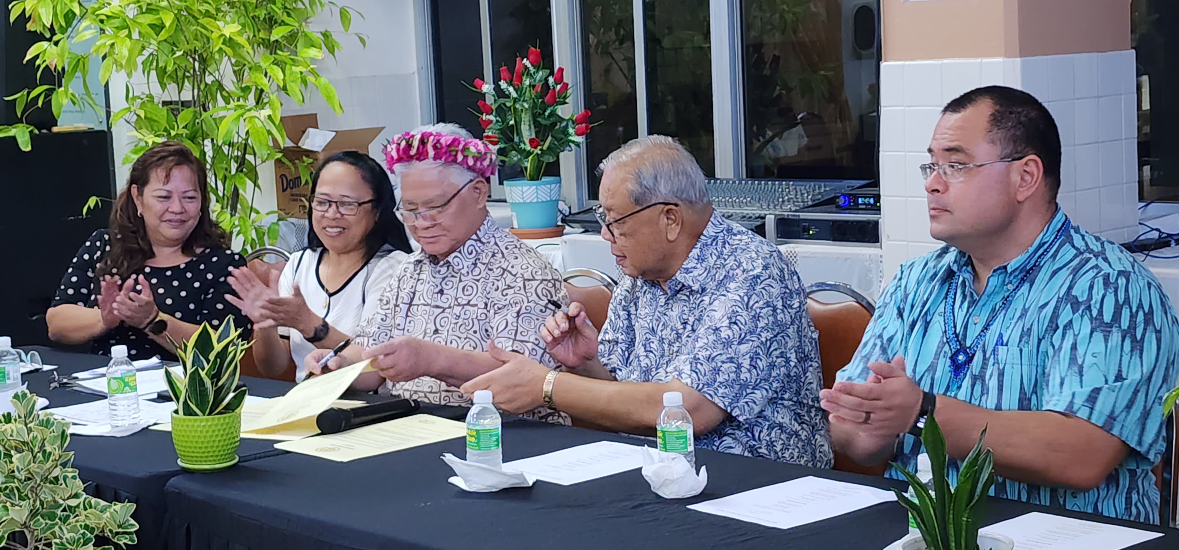 Sen. Celina Babauta, Department of Community and Cultural Affairs Secretary Mary Margaret Sablan and Speaker Edmund S. Villagomez applaud after Gov. Arnold I. Palacios and Lt. Gov. David M. Apatang signed a proclamation declaring May as  Older Americans Month at the CNMI Office on Aging on Thursday.