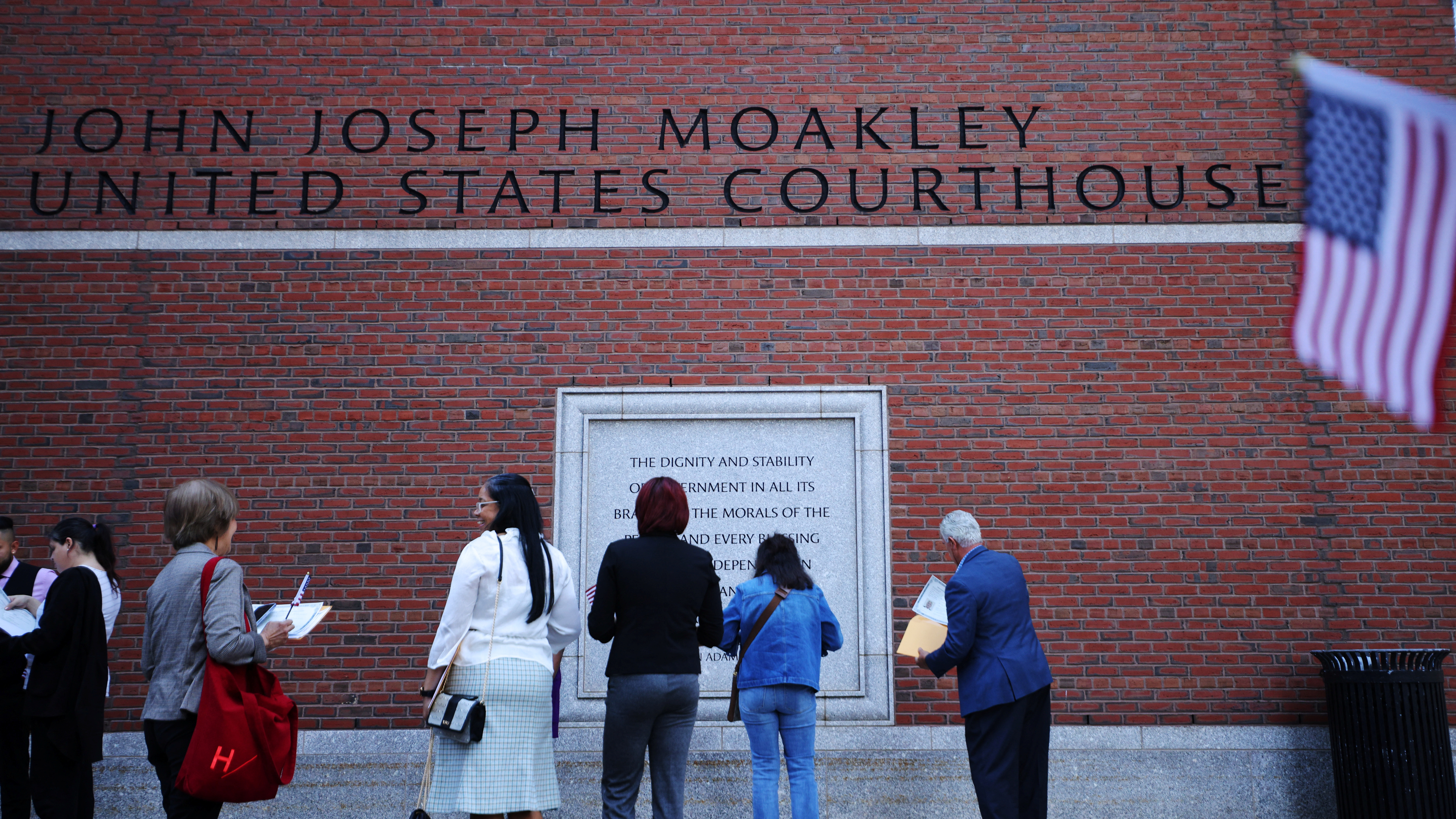 People gather outside the federal courthouse where Jack Teixeira, an Air National Guardsman suspected of leaking highly classified U.S. documents, is expected to be arraigned in Boston, Massachusetts, U.S., April 13, 2023. REUTERS/Brian Snyder