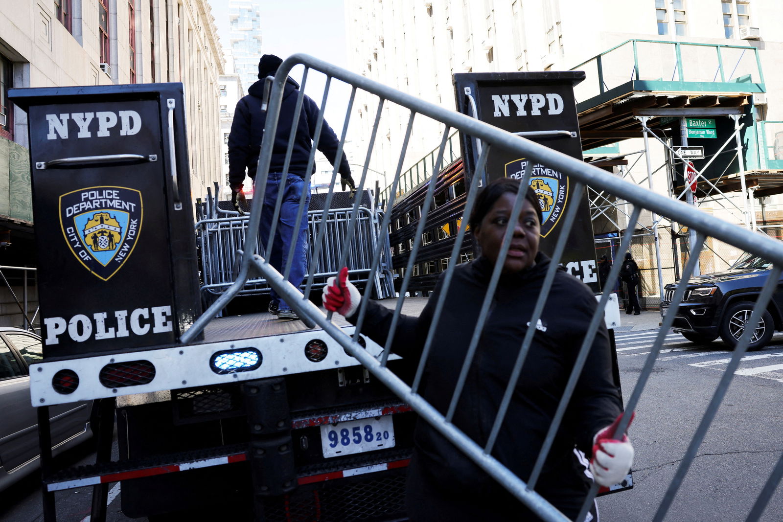 Cap:A person holds a barricade outside the Manhattan Criminal Court, after former President Donald Trump's indictment by a Manhattan grand jury in New York City, April 2, 2023.