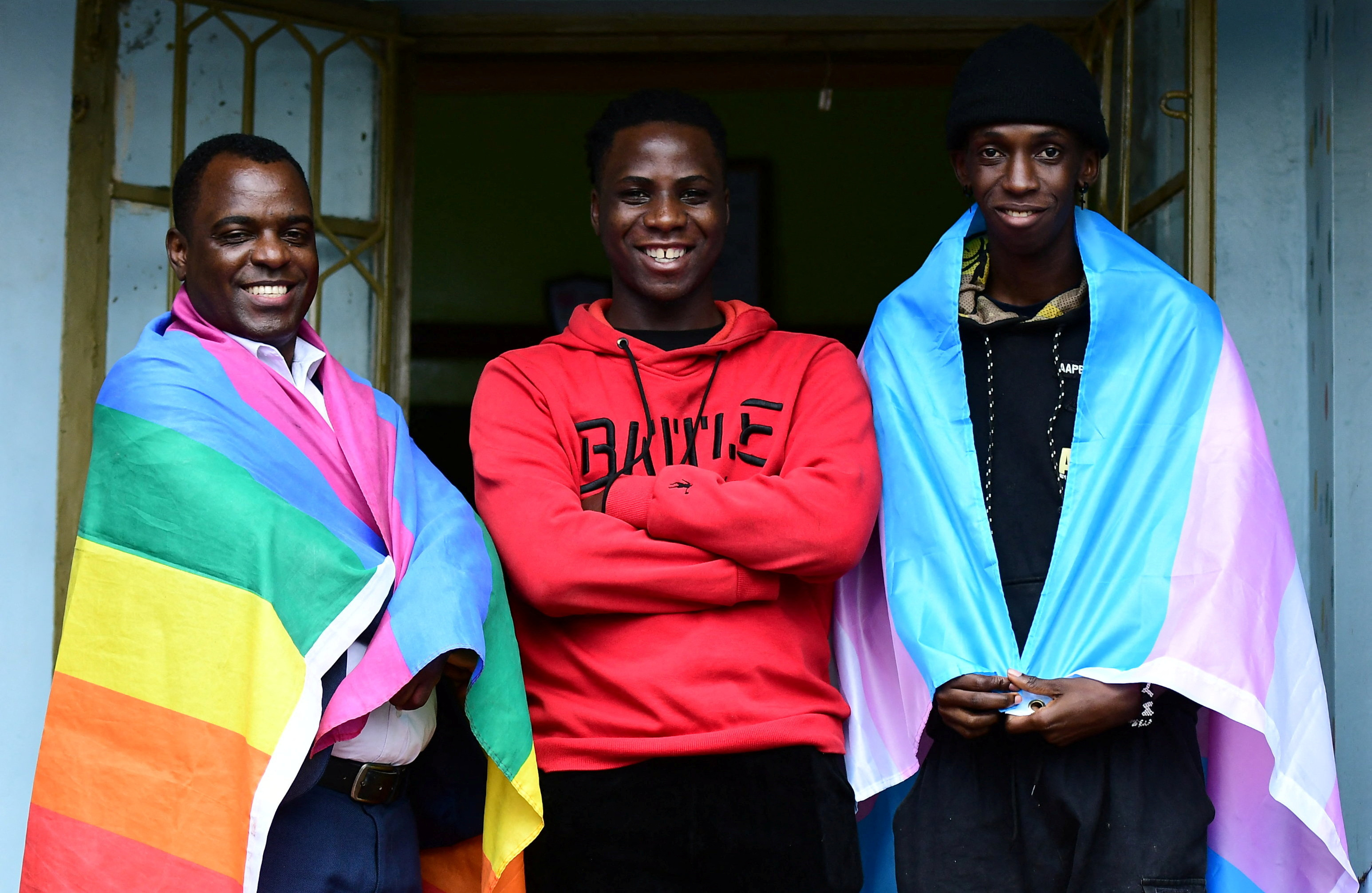 Ugandan LGBTQ activist Frank Mugisha poses for a photograph with LGBTQ members Eric Ndawula and Bana Mwesige after a Reuters interview in Makindye suburb, of Kampala, Uganda March 30, 2023. REUTERS/Abubaker Lubowa