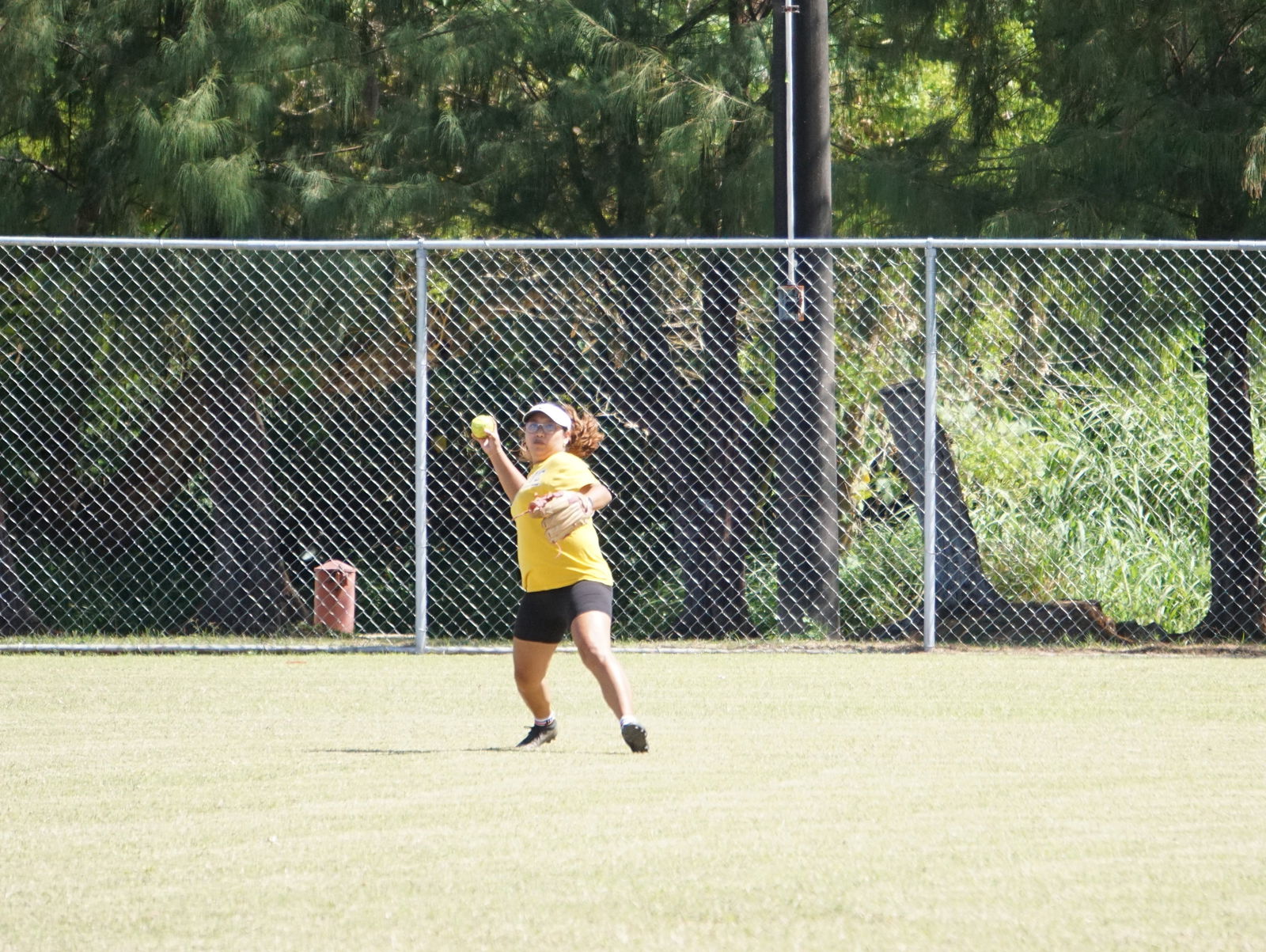 Lady Legals centerfielder Lizann Guerrero gathers for the throw during a ladies division game of the 2023 Budweiser Belau Amateur Softball League at the Dandan baseball field.