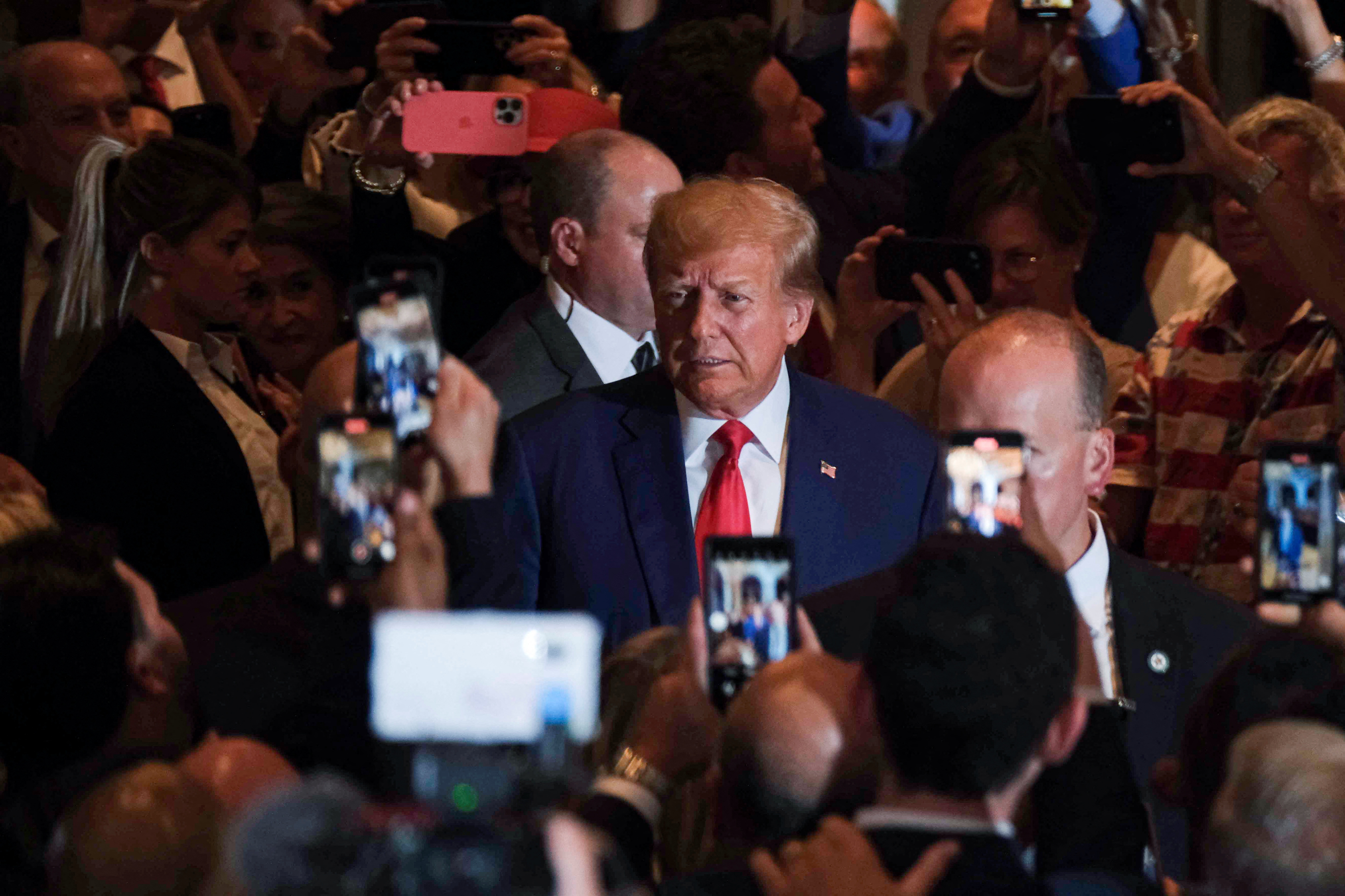 Former President Donald Trump walks amid crowd in Palm Beach, Florida, April 4, 2023.