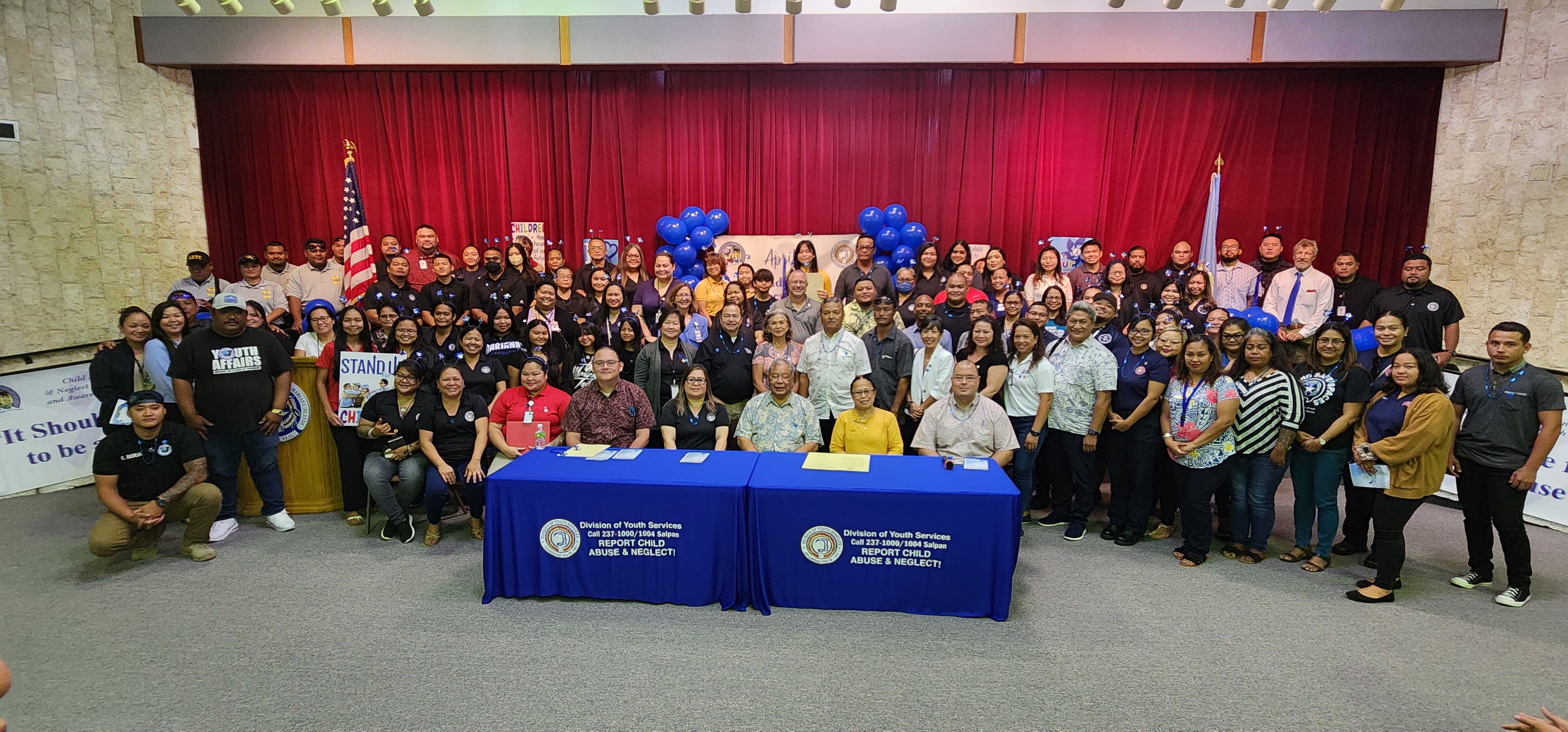 Acting Gov. David M. Apatang poses for a photo with other government officials, personnel, advocates and community members after signing a proclamation designating April as Child Abuse and Neglect Prevention and Awareness Month on Tuesday at the multi-purpose center.