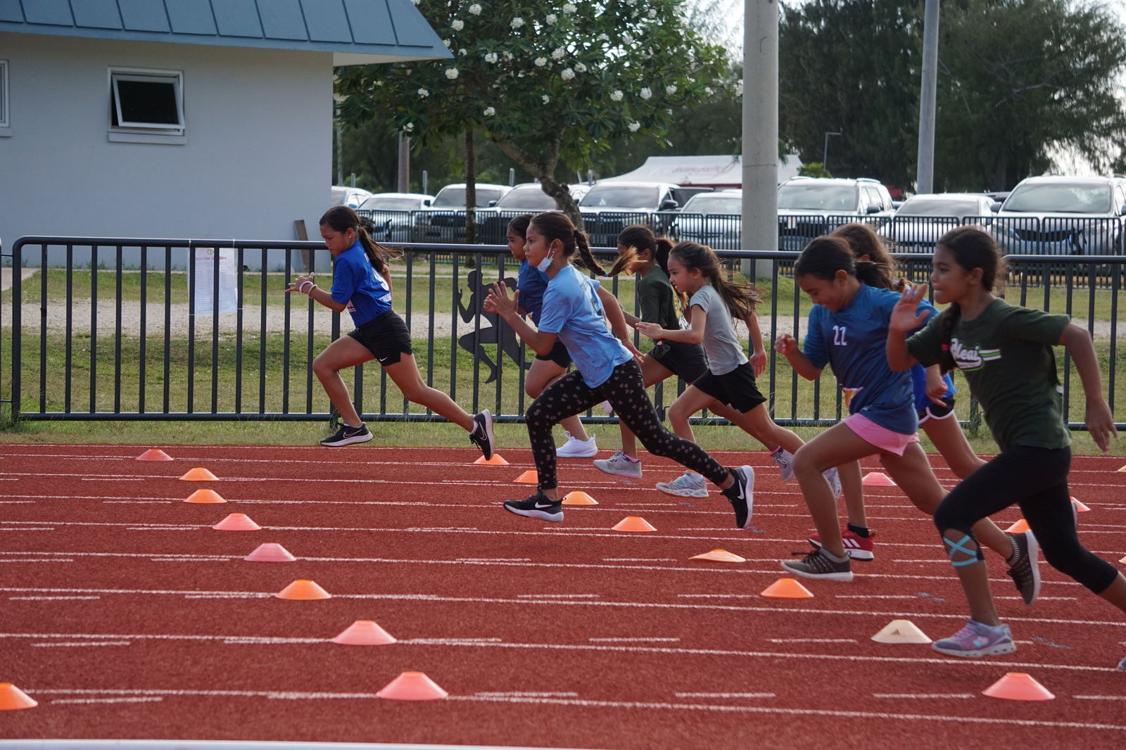 Runners take off during a U9 girls 100m event of the PSS-NMA All School Athletics on Friday at the Oleai Sports Complex.