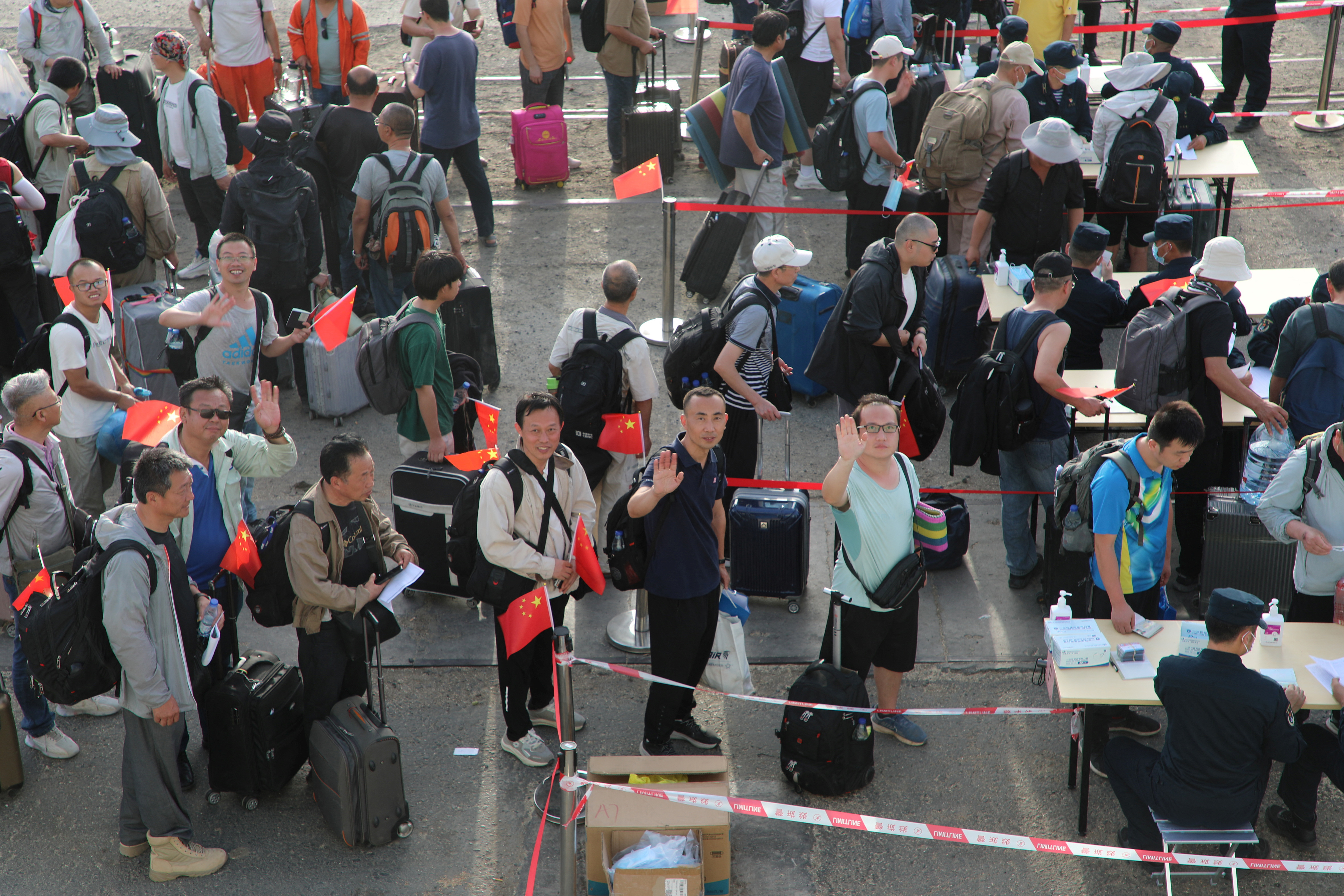 People line up for checks at Port Sudan as Chinese People's Liberation Army (PLA) Navy dispatched ships for an evacuation mission in Sudan April 26, 2023. cnsphoto via REUTERS