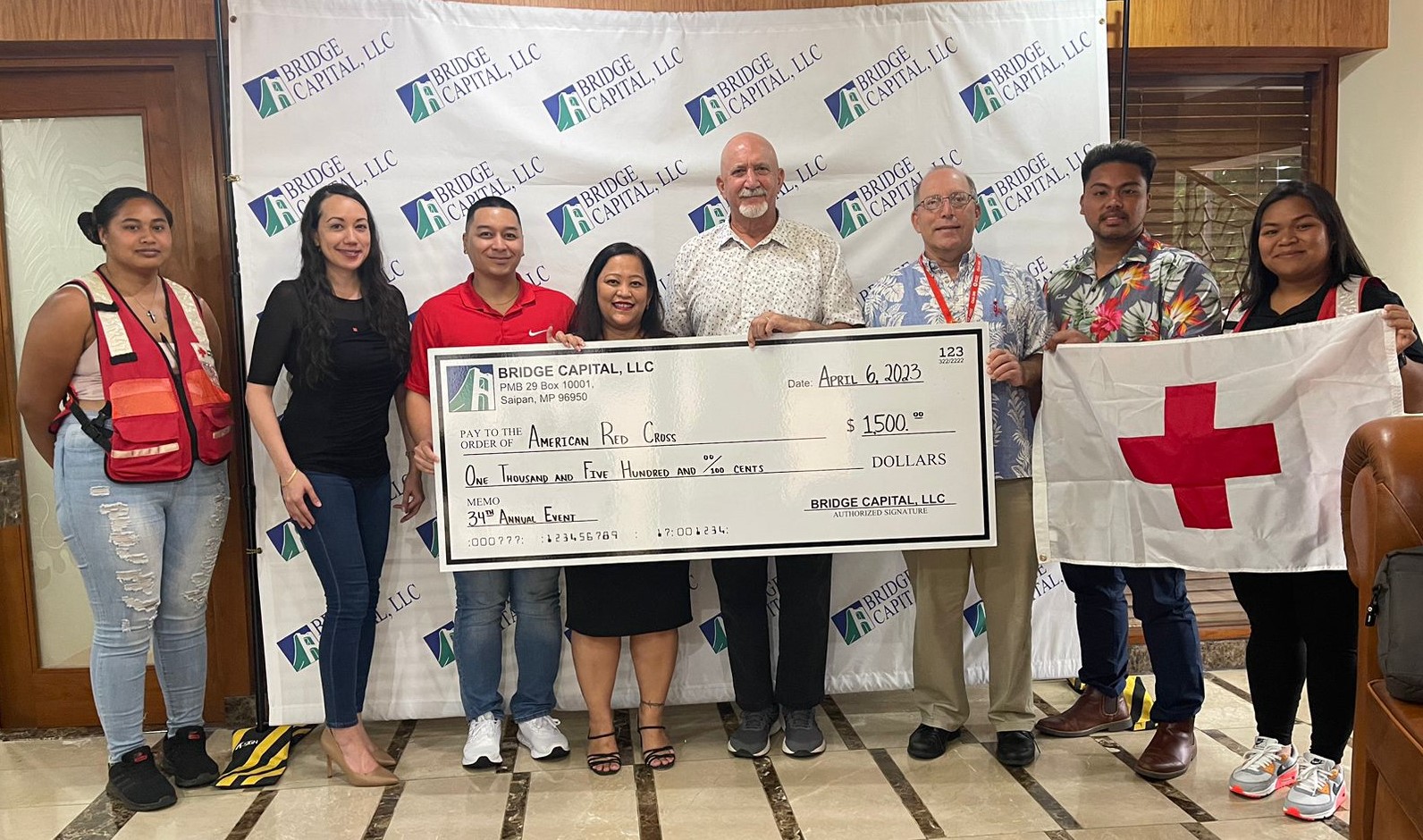 Bridge Capital LLC Managing Director Bart Jackson and office manager Julie Duenas presenting a $1,500 donation for the NMI chapter in support of the Red Cross Walkathon. Also pictured: Triana Palemai, disaster volunteer; Patty Palacios, board member; Brent Deleon Guerrero, board member; John Hirsh, executive director; Bobby Cruz, board member and Selmalyn Taitano, business operations manager.