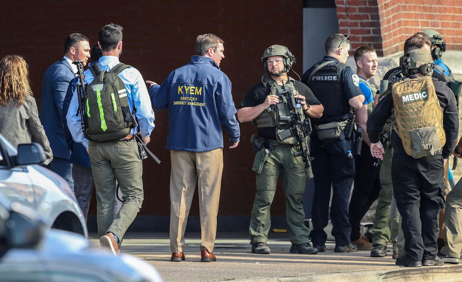 Kentucky Governor Andy Beshear speaks with police deploying at the scene of a mass shooting near Slugger Field baseball stadium in downtown Louisville, Kentucky, U.S. April, 10, 2023. Michael Clevenger/USA Today Network via REUTERS.