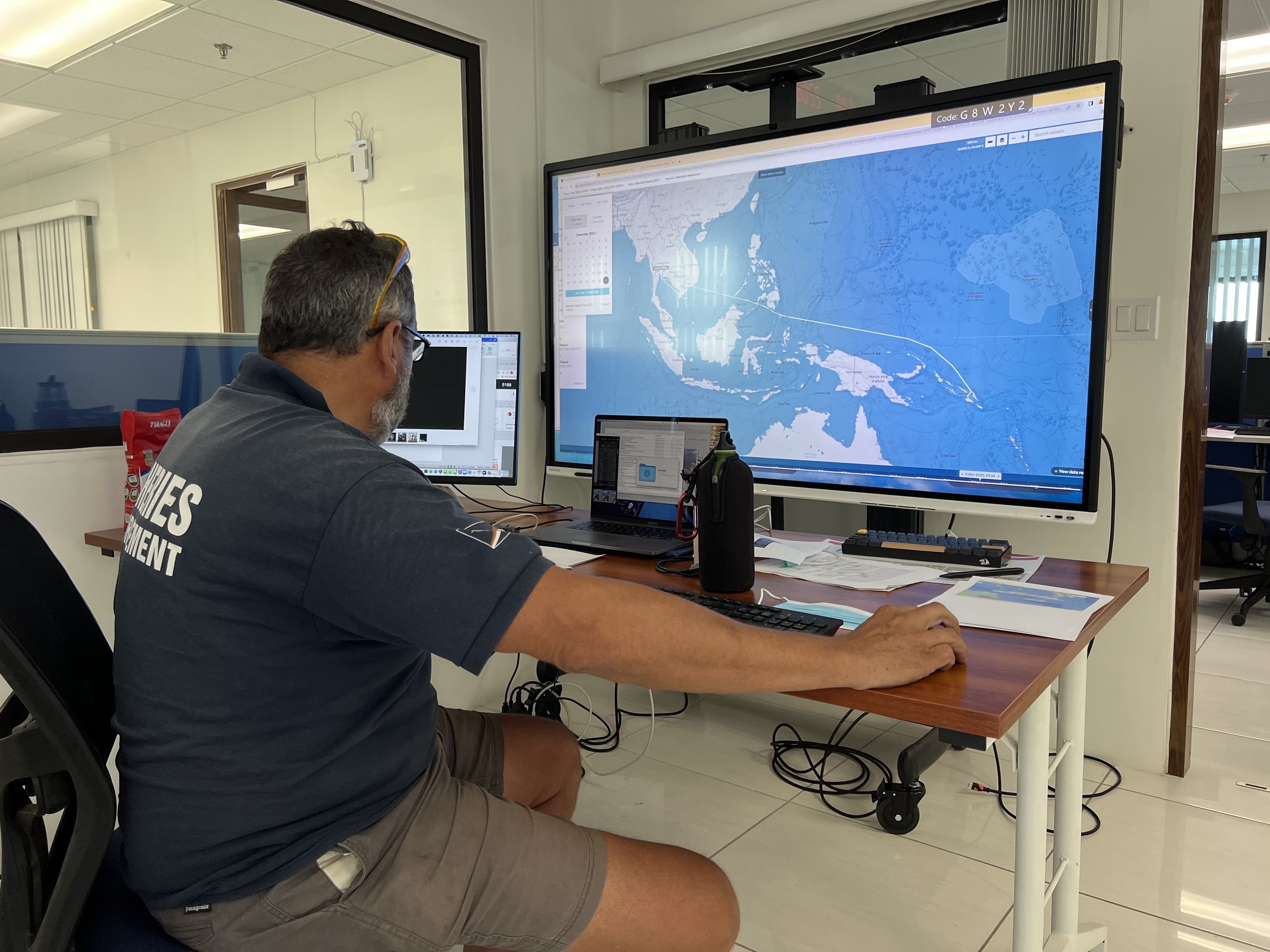 Marshall Islands Marine Resources Authority's offshore fisheries advisor Francisco Blaha at the fisheries authority's Majuro headquarters reviews satellite imagery of fishing vessels active in the western Pacific region.