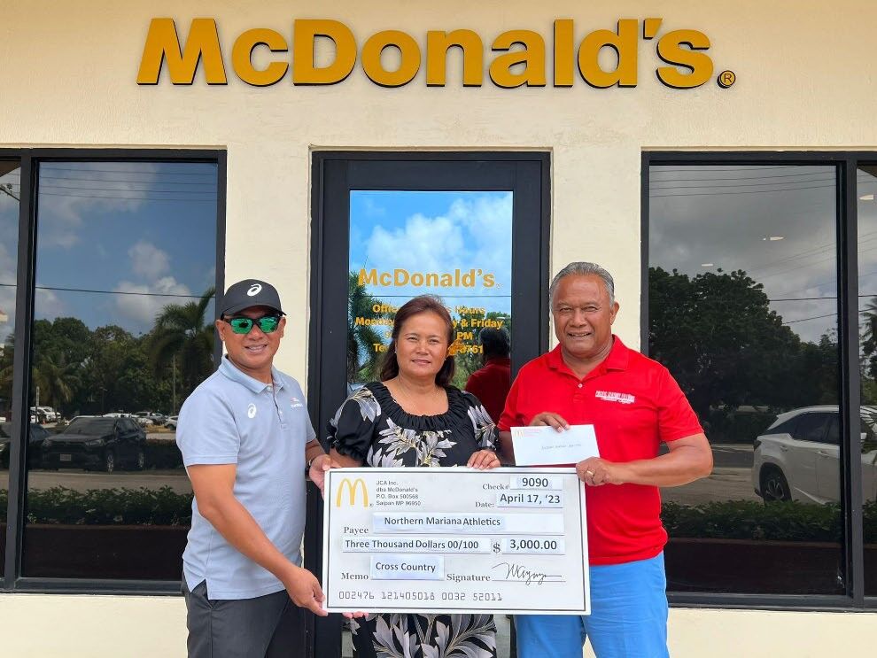 From left, Robin Sapong, Northern Marianas Athletics general secretary; Marica Erra Ayuyu, vice president and owner/operator, McDonald’s of Guam and Saipan; and Ramon Tebuteb, Northern Marianas Athletics president.