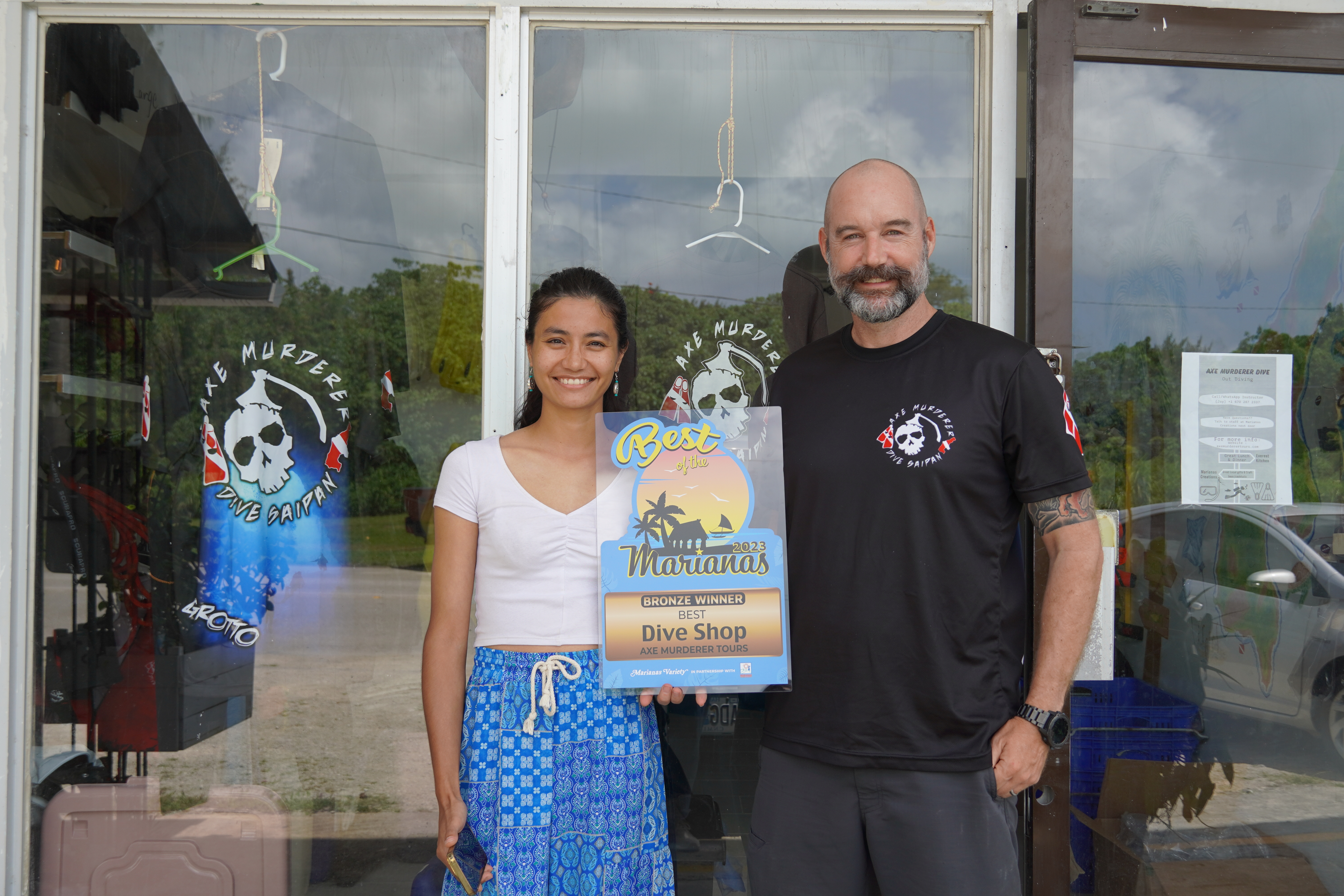 Axe Murderer Tours' Jay Wolfe and his wife receive the Bronze award for Best Dive Shop of the Marianas.