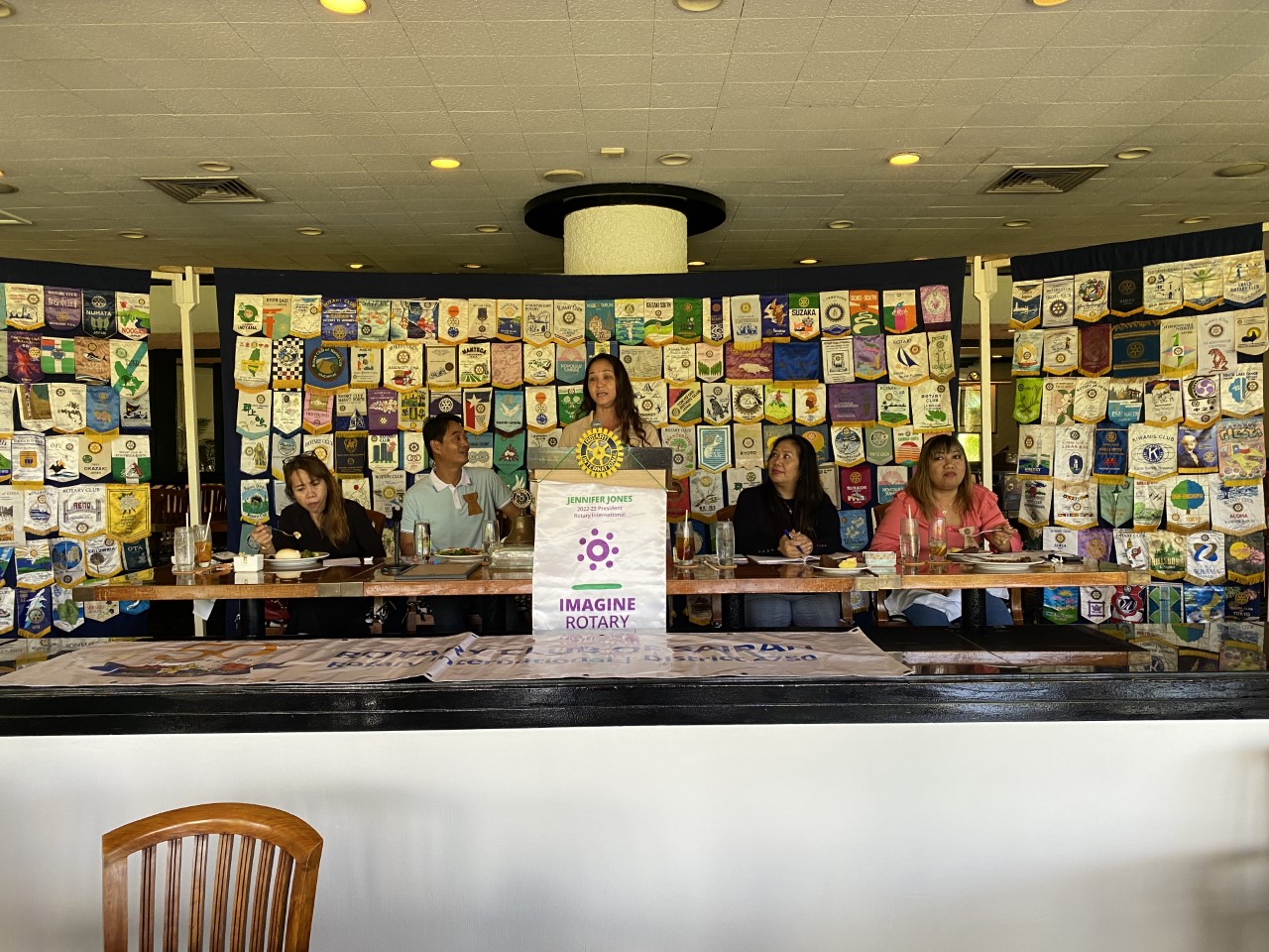 Robin Palacios, standing behind the podium, speaks to Rotarians about Early Intervention Services. Also in photo: Rotary Club of Saipan President-elect Irene Holl, President Wendell Posadas, Secretary Joann Aquino and Vice President Jessy Loomis.