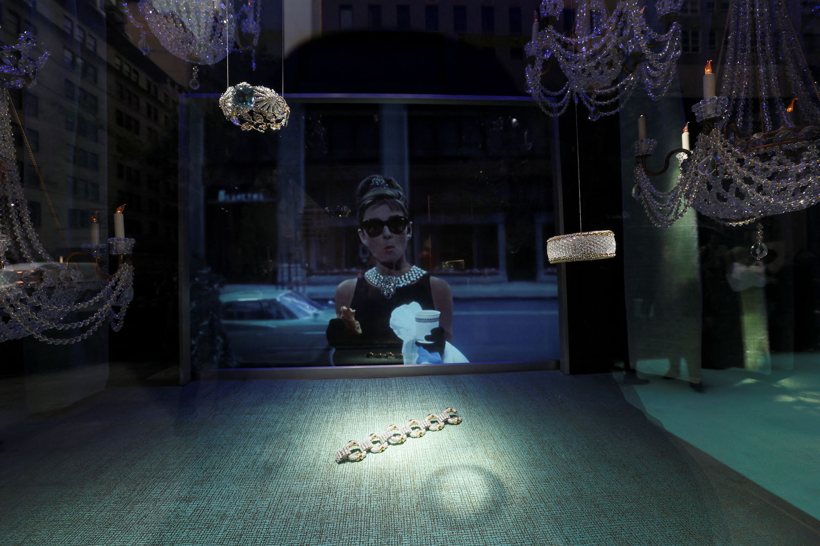 A scene from the movie "Breakfast at Tiffany's" is played in a store window, during a ribbon cutting ceremony for reopening of the Tiffany flagship store on 5th Avenue in Manhattan in New York City, New York, U.S., April 26, 2023. REUTERS/Brendan McDermid