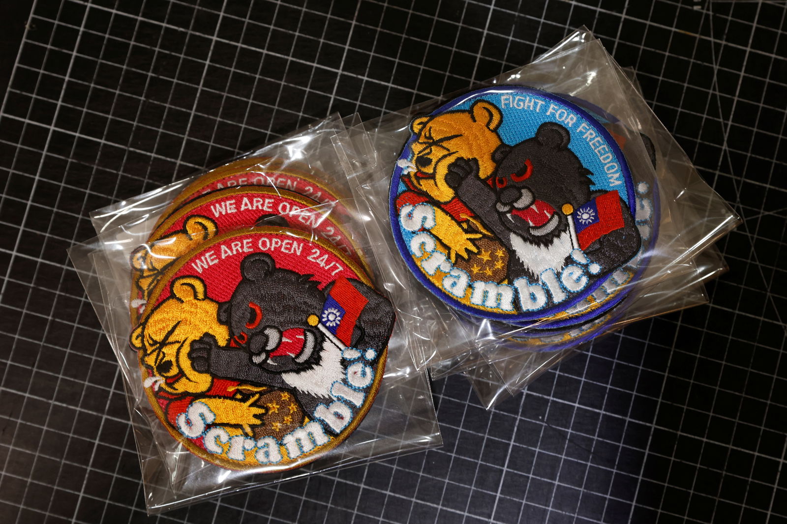Patches depicting a Formosan black bear holding Taiwan’s flag and punching Winnie the Pooh, are pictured while displayed for the cameras at a store in Taoyuan, Taiwan, April 10, 2023. 