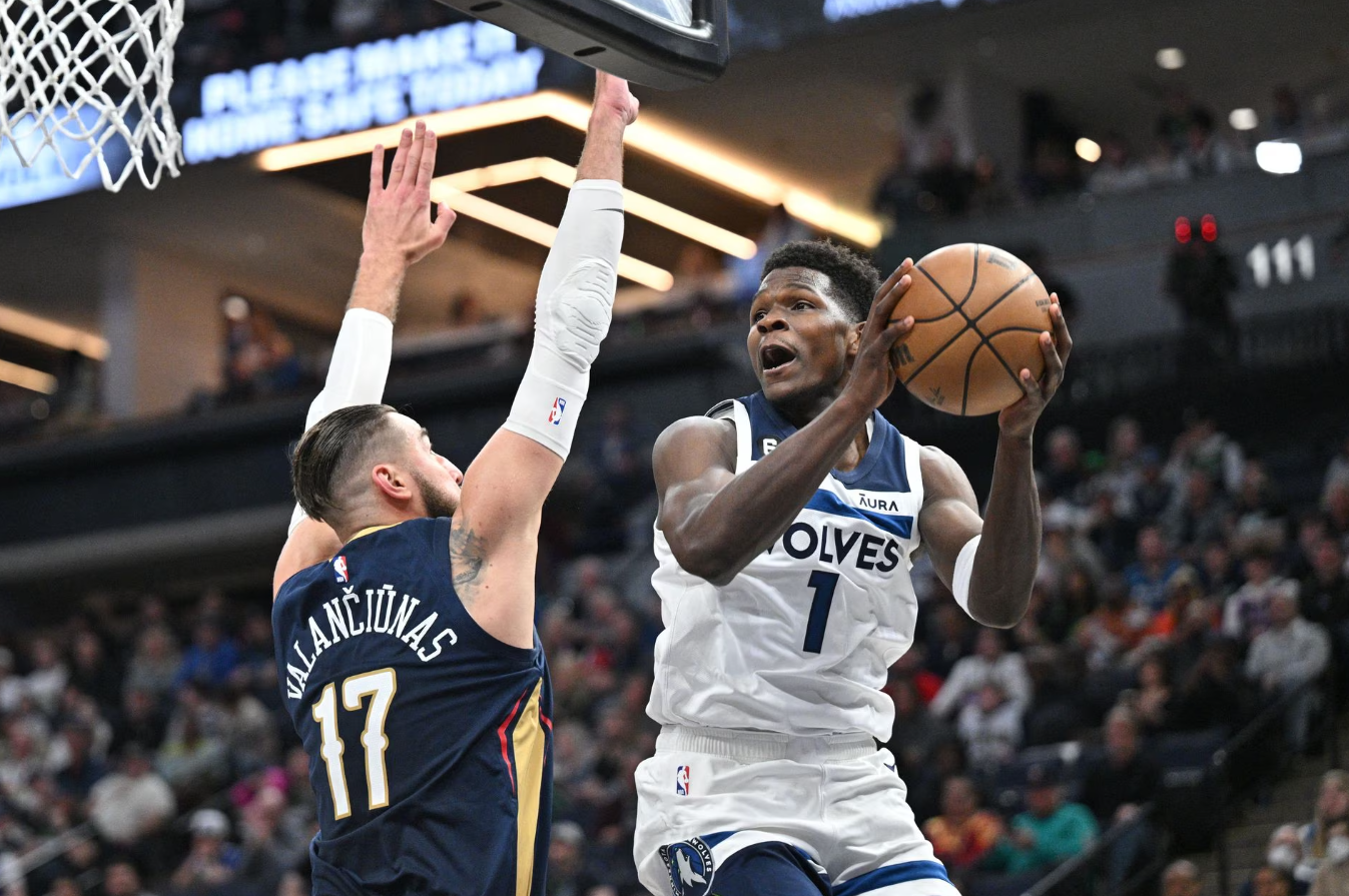 Minnesota Timberwolves guard Anthony Edwards (1) goes to the basket as New Orleans Pelicans center Jonas Valanciunas (17) defends during the second quarter at Target Center in Minneapolis, Minnesota, April 9, 2023.
