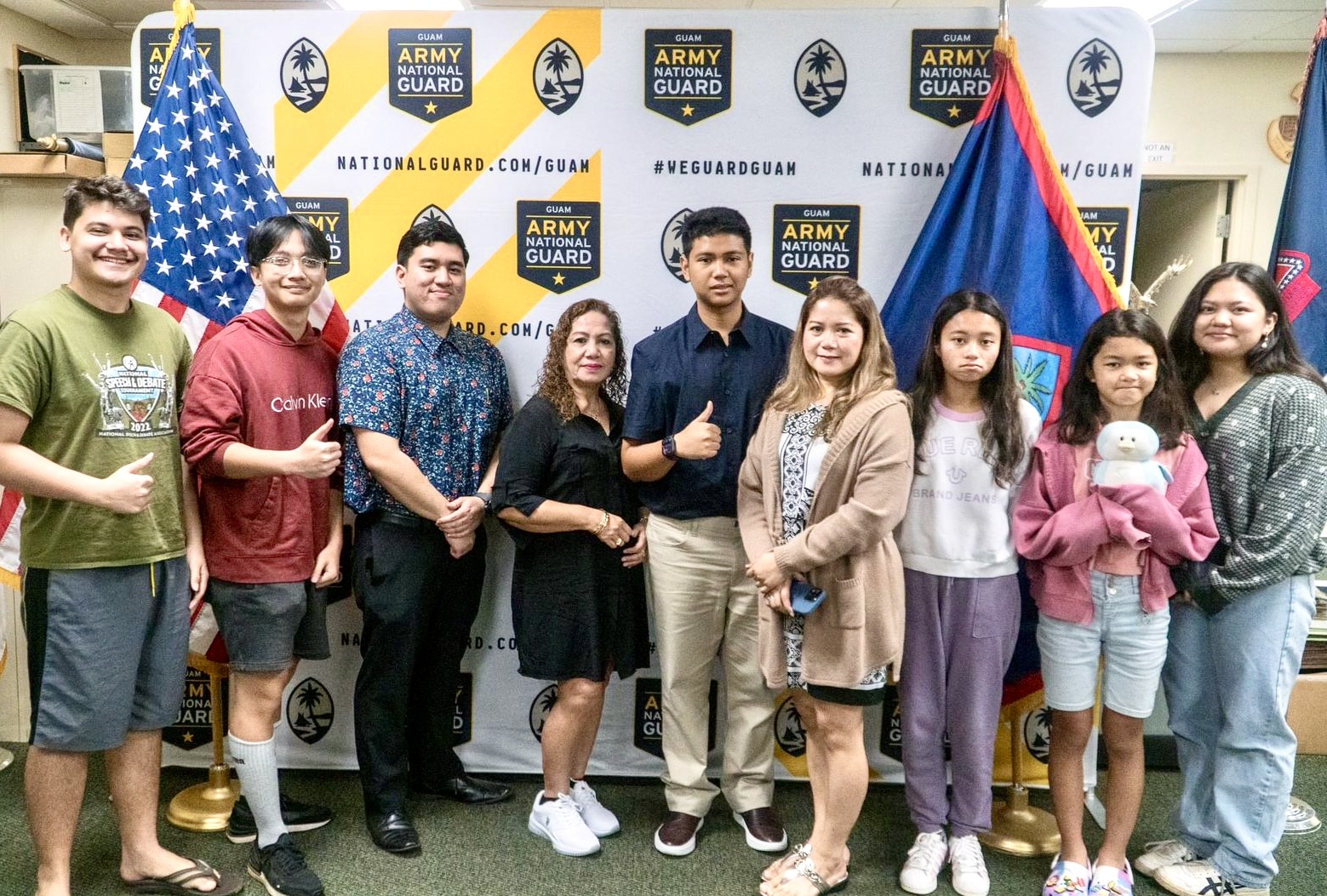 From left, Jonathan Wolf and Haley Sangalang join friends and family member during the oathtaking of Ydrane Sanje, 5th left. Also in photo are Darryl Aurelion Cely Lizama, Ysharei Sanje, Arlene Lizama, Ysharei Sanje, Iyani Muna and Rannon Palacios.