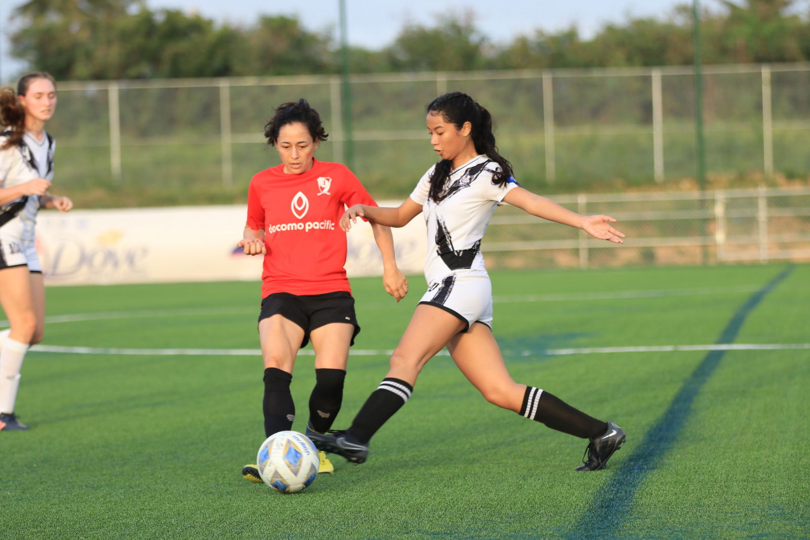 Southern United FC's Keisha Deleon Guerrero extends in an attempt to intercept the possession against a Paire player during an intermediate division game of the Dove Women's League at the NMI Soccer Training Center.