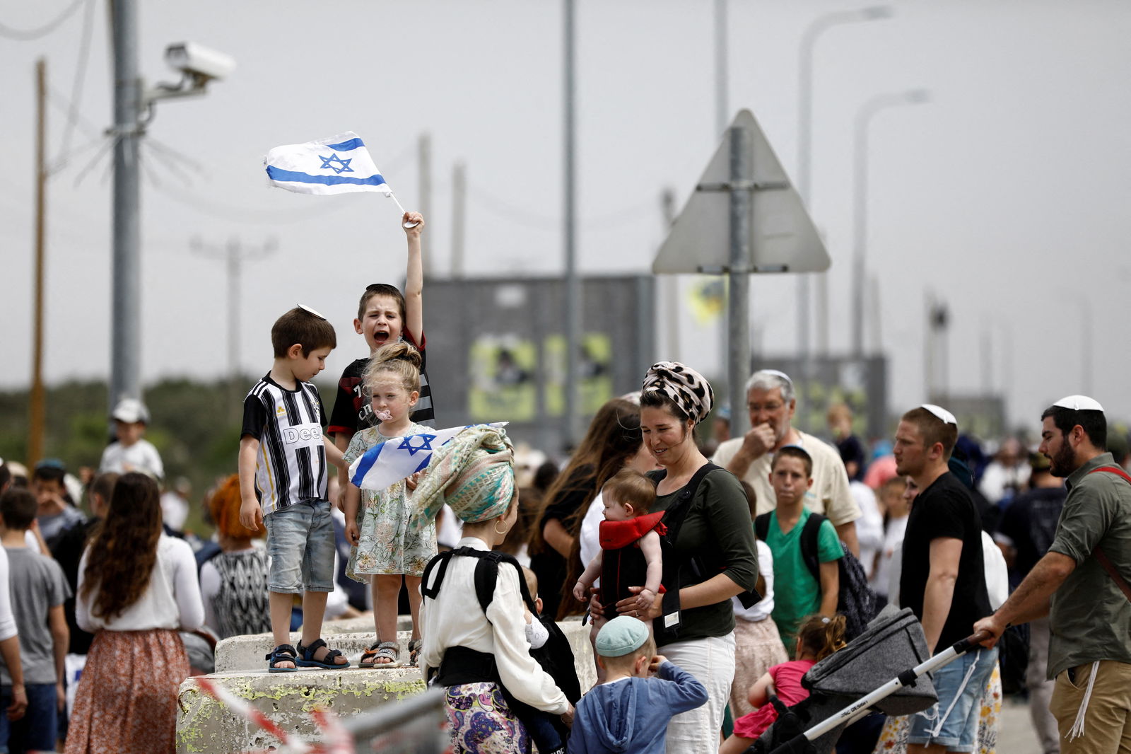 A child reacts, holding Israel's national flag, as Israeli settlers hold a protest march from Tapuach Junction to the Israeli settler outpost of Evyatar, in the Israeli-occupied West Bank, April 10, 2023. REUTERS/Nir Elias