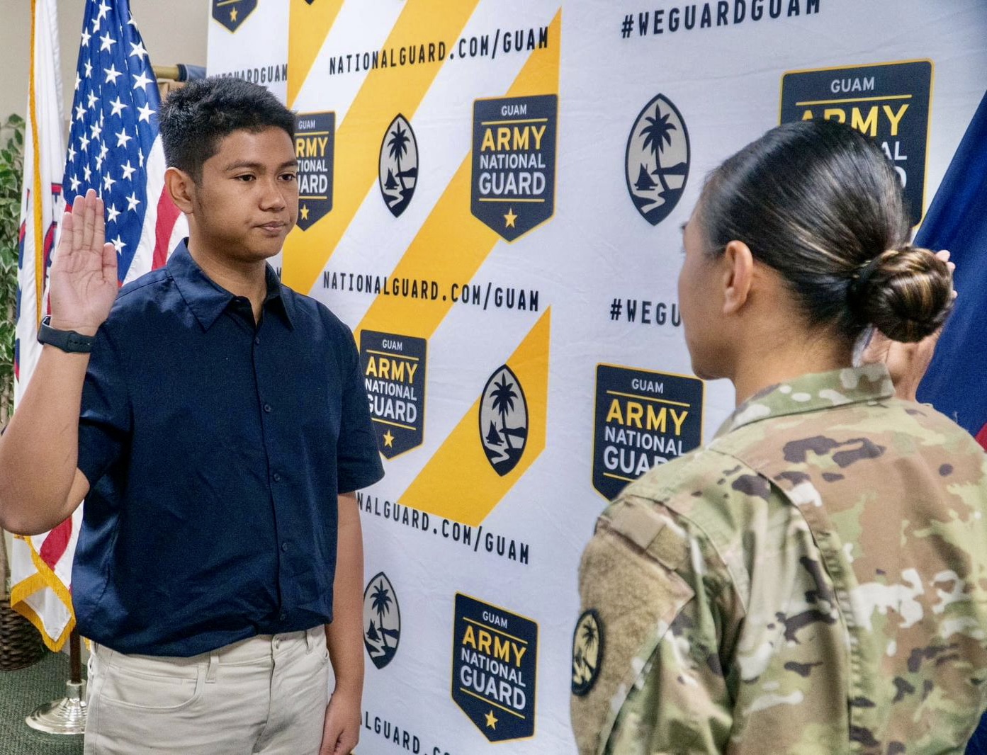 Ydrane Sanje, left, takes his oath of enlistment as a member of the Army National Guard on Guam on April 7, 2023.