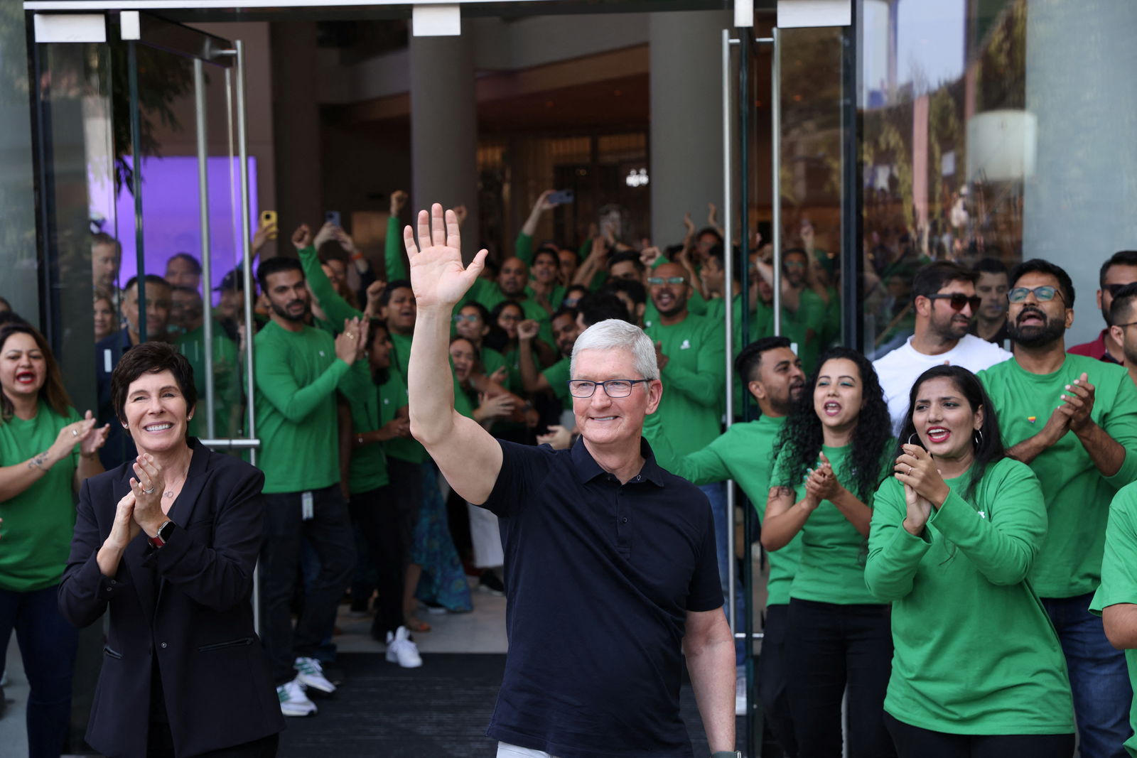 Apple CEO Tim Cook and Deirdre O'Brien, Apple's senior vice president of Retail and People greet people at the inauguration of India's first Apple retail store in Mumbai, India, April 18, 2023. REUTERS/Francis Mascarenhas