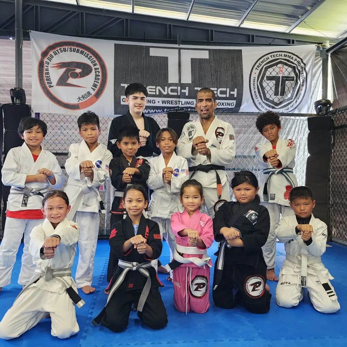 Cuki Alvarez and the Trench Tech kids pose for a photo. The young martial artists  competed in the Patgon (Kids) Jiu-Jitsu Tournament Spring 2023 on Saturday, April 22, at the University of Guam.