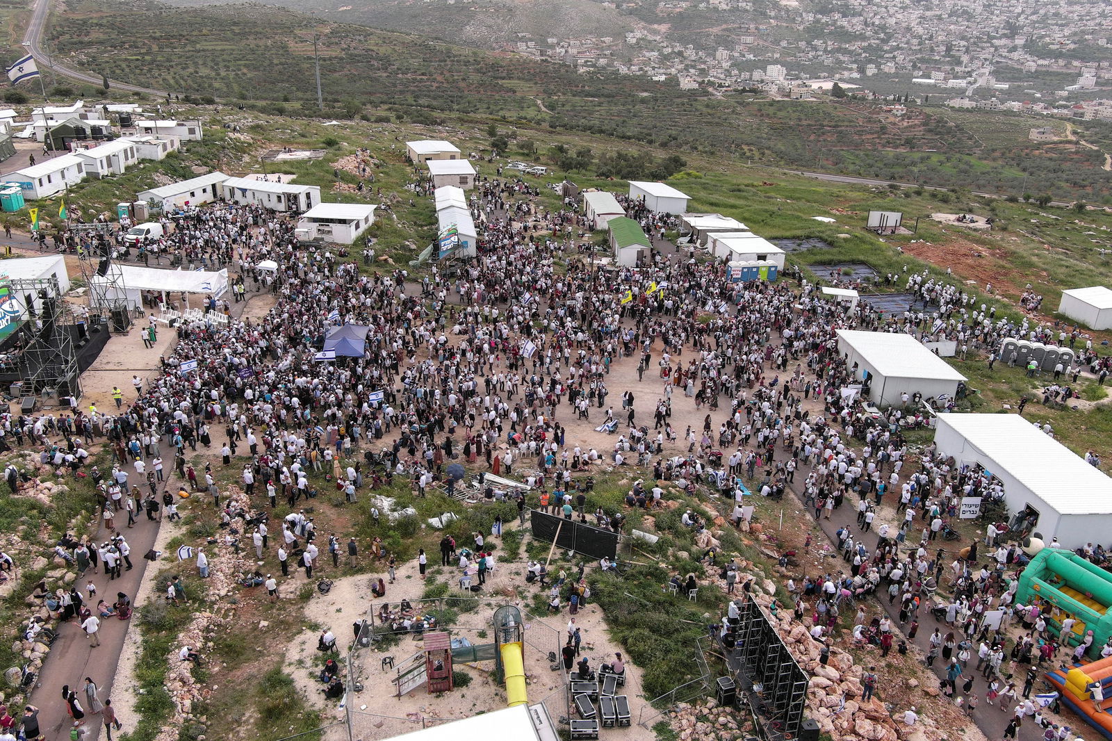 Israeli settlers gather at the Israeli settler outpost of Evyatar, as part of a protest march from Tapuach Junction to Evyatar in the Israeli-occupied West Bank, April 10, 2023. REUTERS/Ilan Rosenberg
