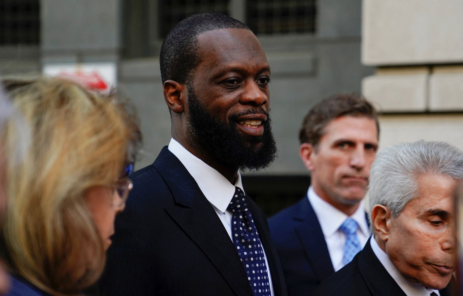 Grammy Award-winning rapper Prakazrel "Pras" Michel of the hip hop group "The Fugees" leaves U.S. federal court with his attorneys after being convicted on criminal charges that he conspired with a Malaysian financier to orchestrate a series of foreign lobbying campaigns aimed at influencing the U.S. government, in Washington, U.S. April 25, 2023. REUTERS/Nathan Howard