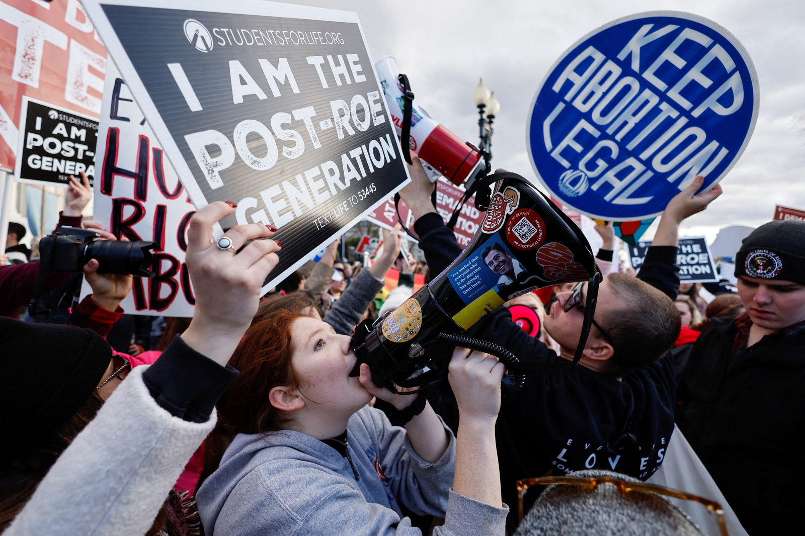 FILE PHOTO: Abortion rights campaigners and anti-abortion demonstrators hold signs during the annual "March for Life" for the first time since the U.S. Supreme Court overturned Roe v Wade abortion decision, in Washington, U.S. January 20, 2023. REUTERS/Jonathan Ernst
